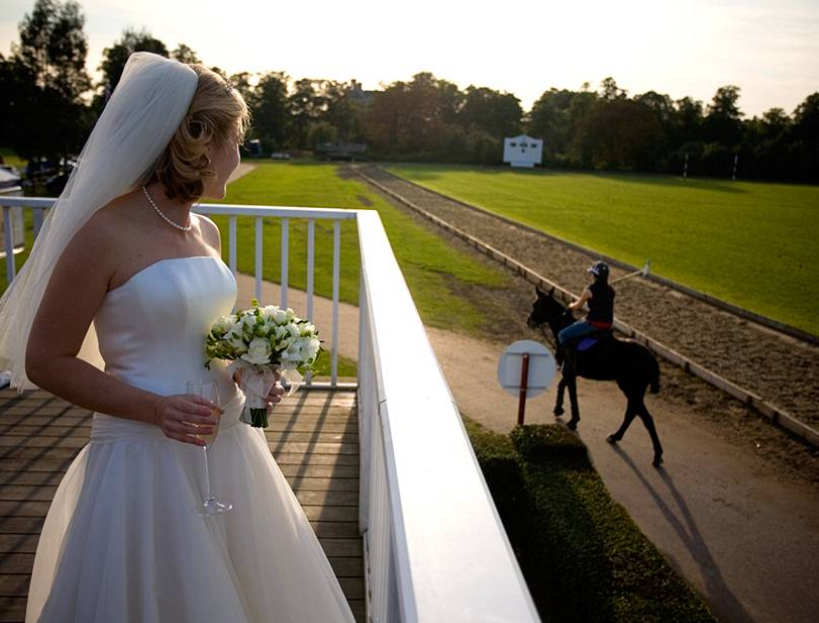 Bride in stunning gown on Ham Polo Club rooftop terrace, perfect for elegant weddings.