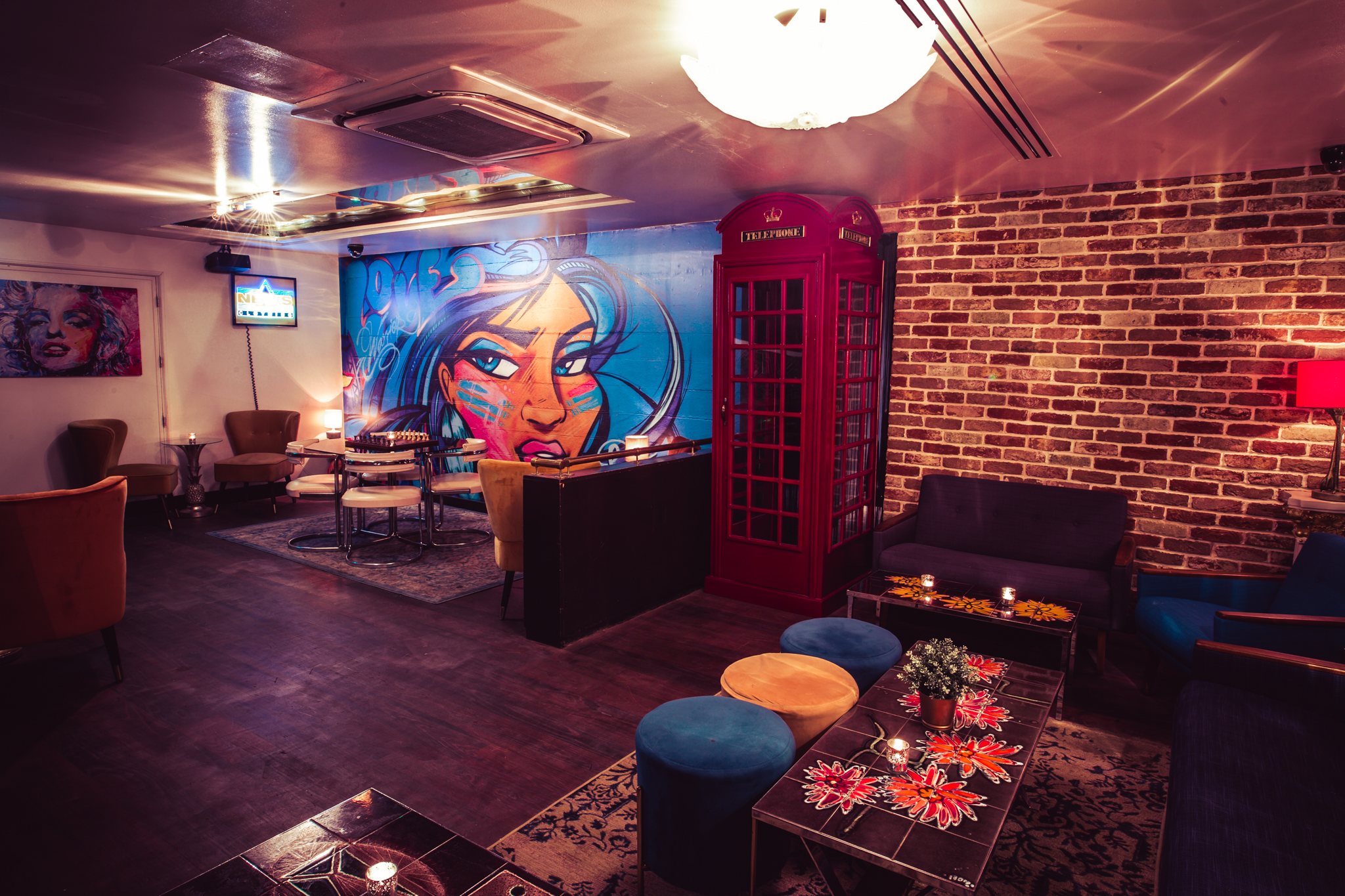 Geisha Lounge event space with vibrant mural, ideal for gatherings and networking. - Banner