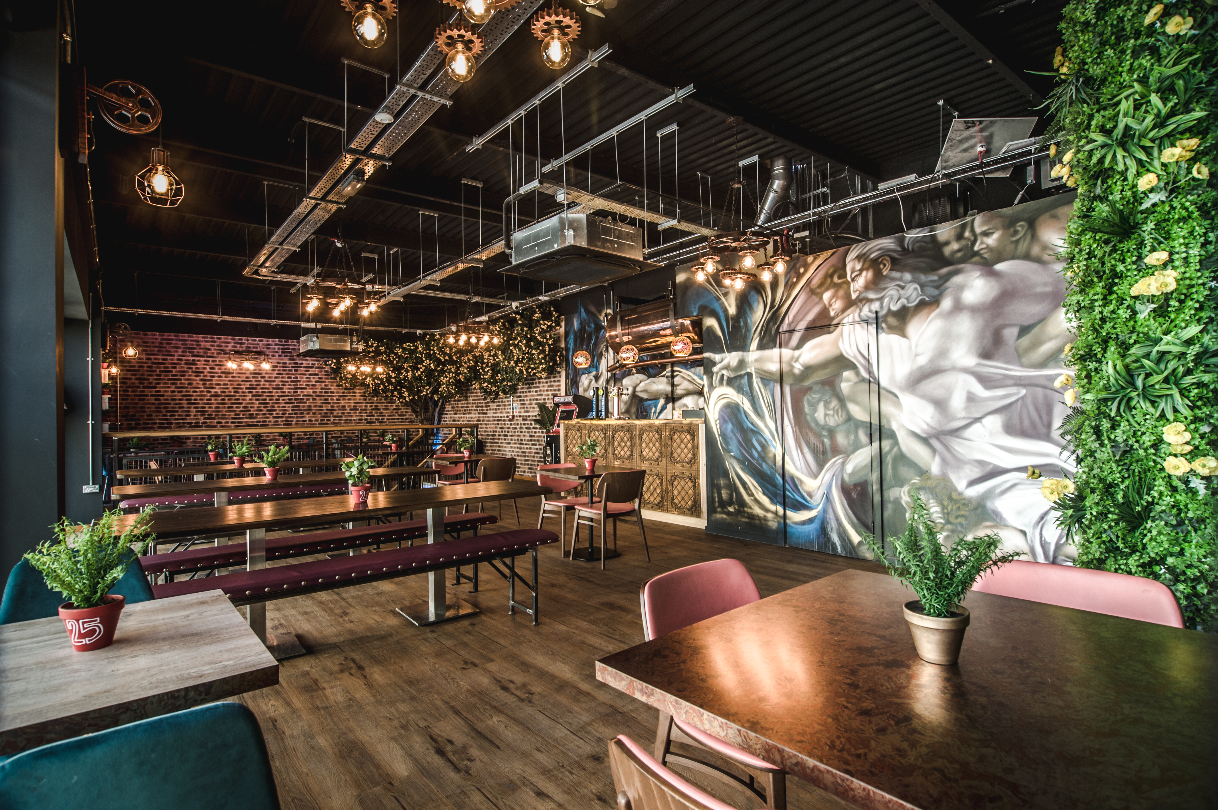 Stylish event space in Dough Dough Liverpool with vibrant mural and greenery. - Banner