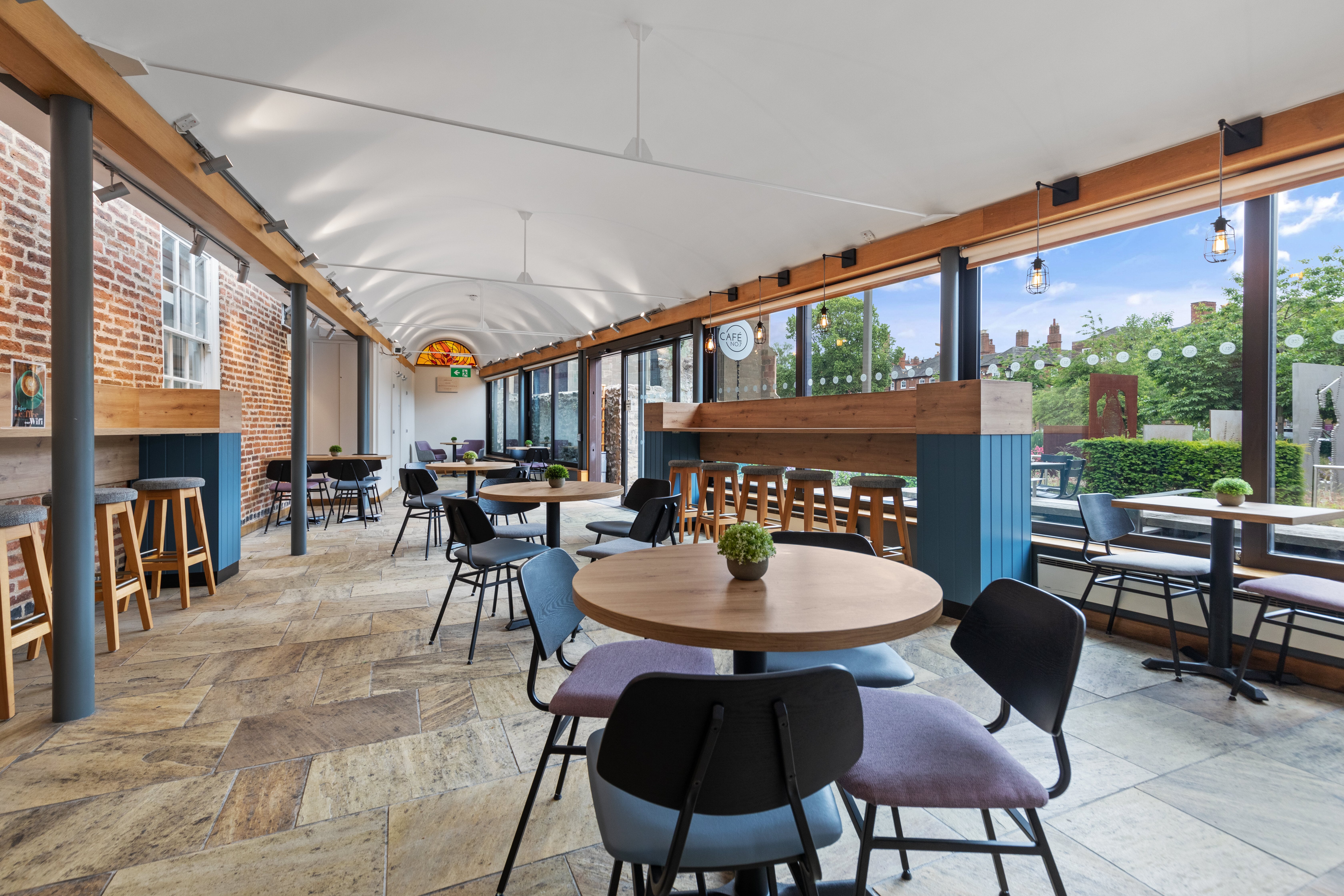 Modern event space at Cafe No:7 with large windows for networking and meetings.