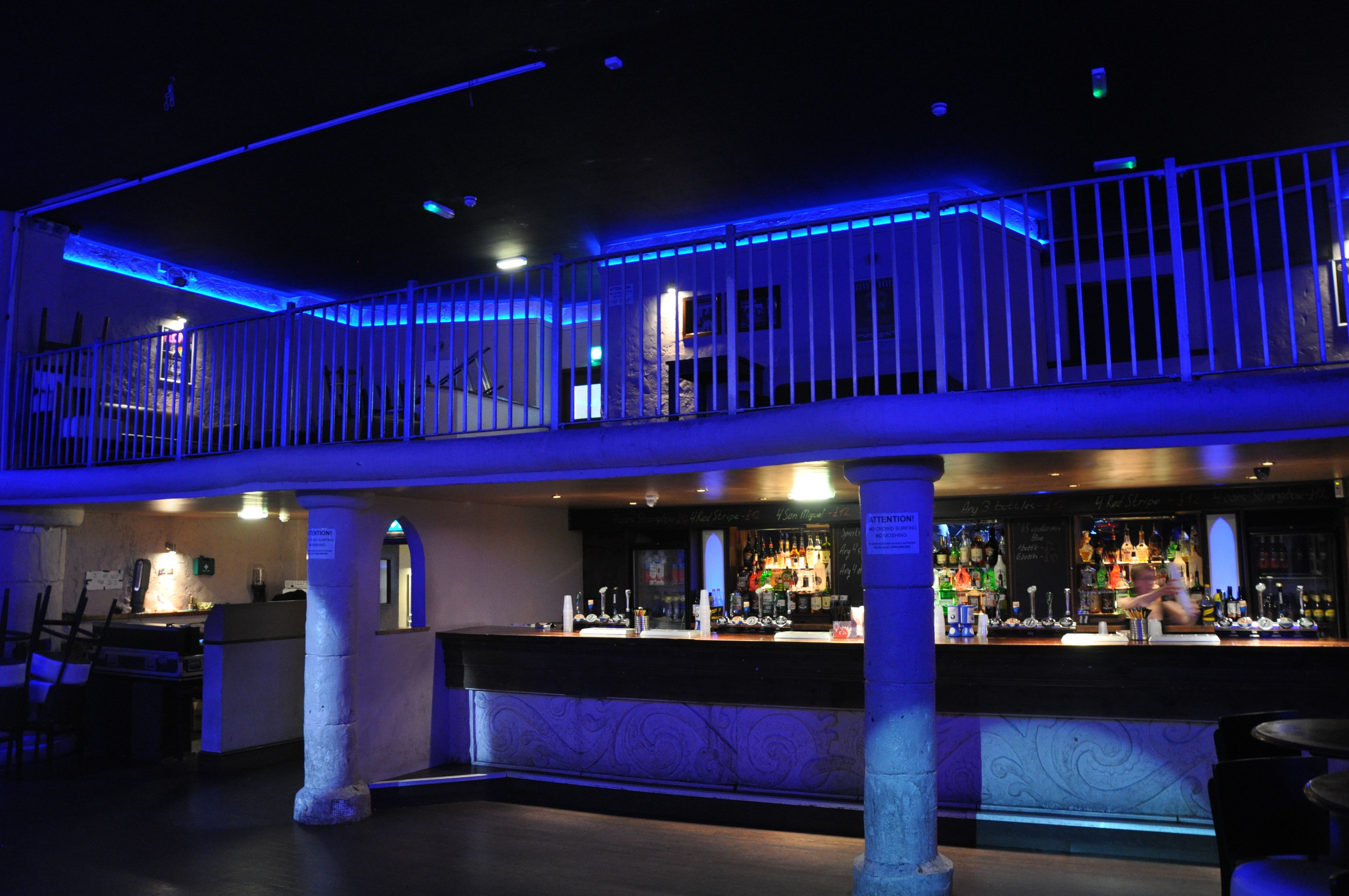 Modern event space in The Globe Cardiff with blue lighting, ideal for cocktail receptions.