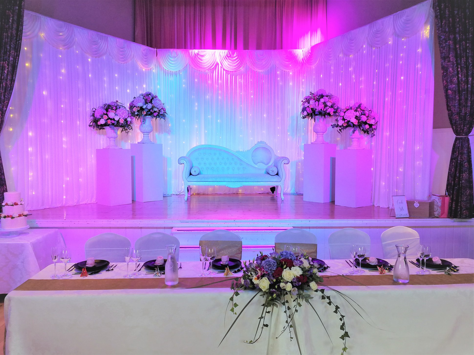 Elegant event space with stylish settee, perfect for weddings and upscale gatherings.