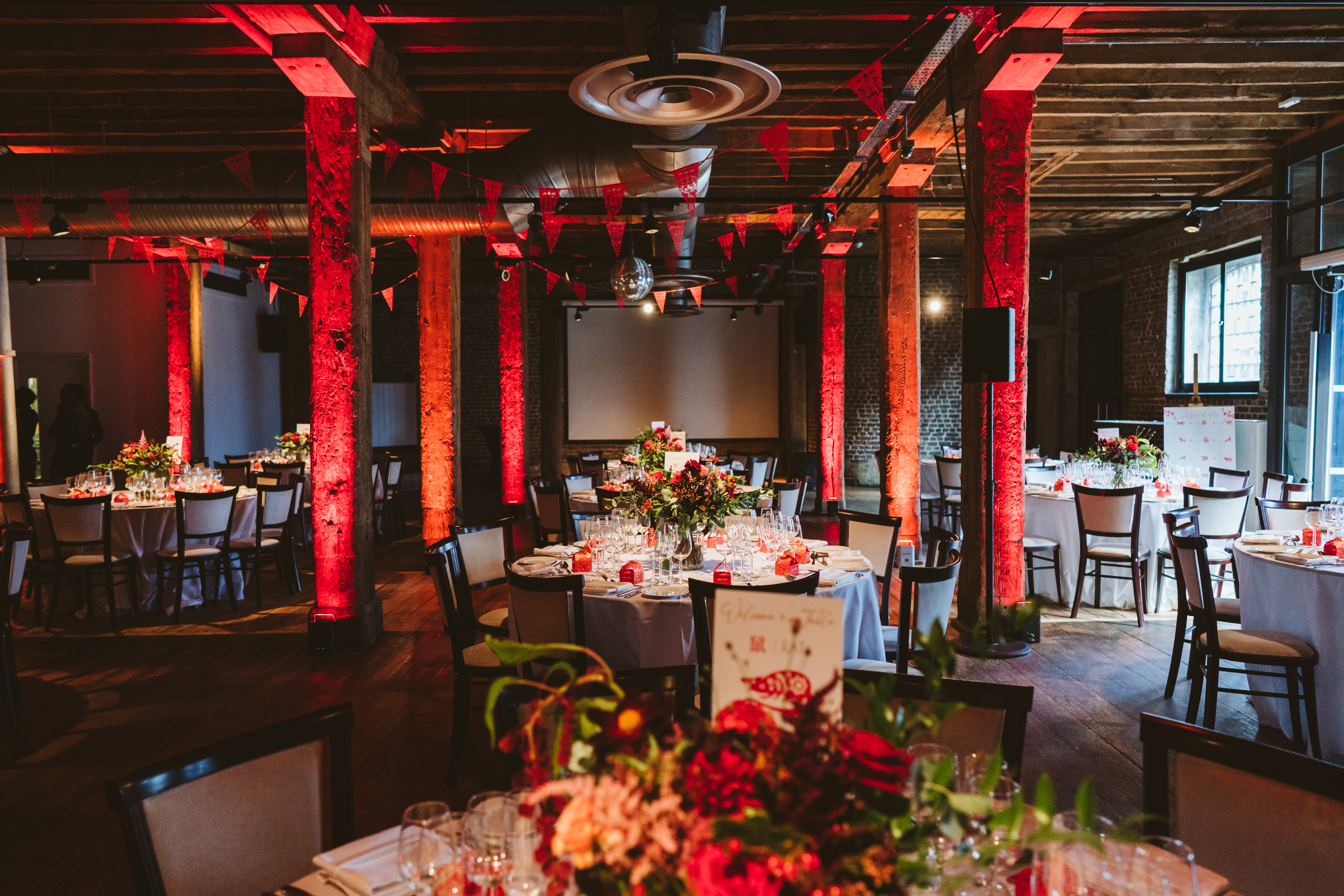 Riverside Room at London Museum Docklands, elegant event space with floral centerpieces. - Banner