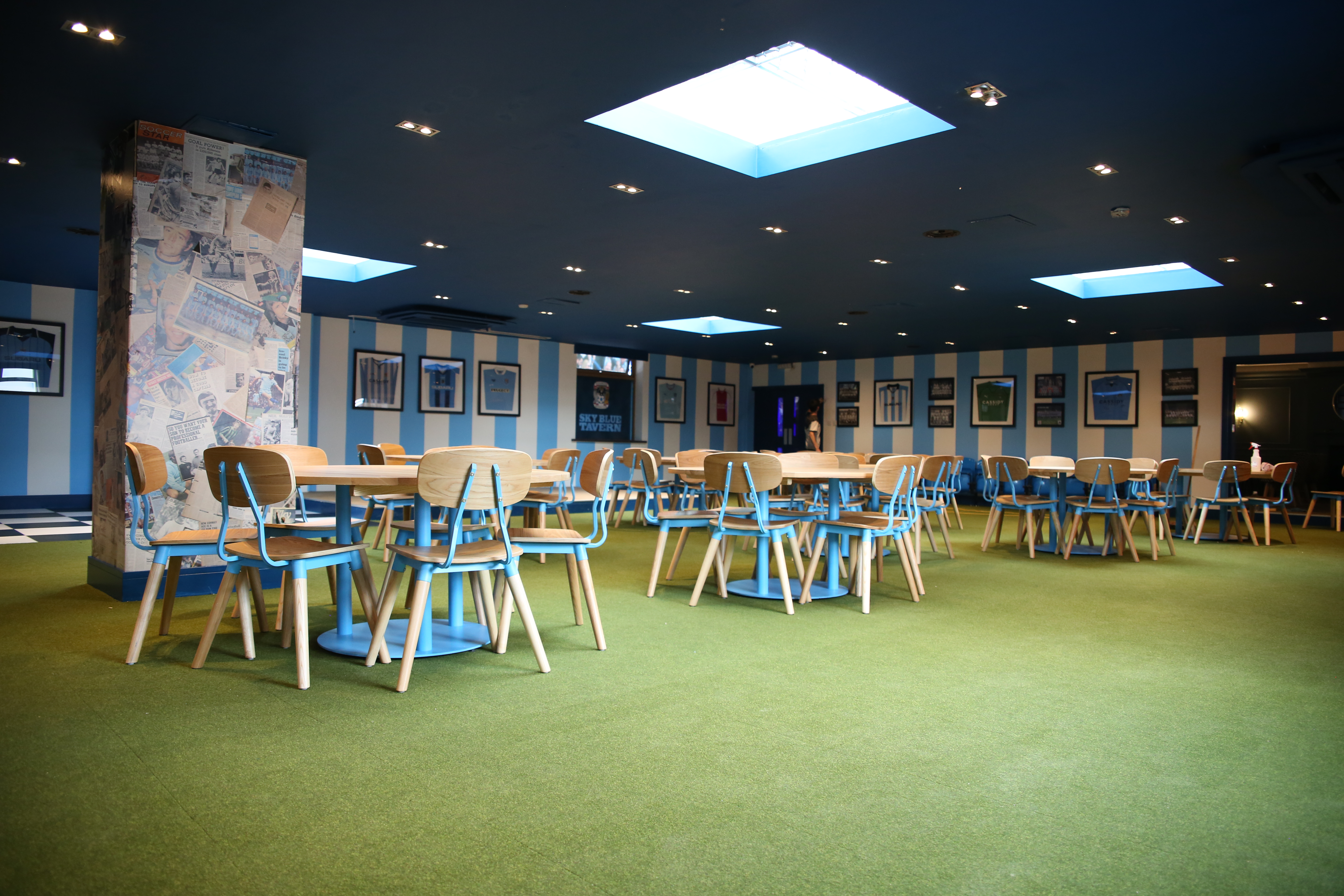 Versatile event space in Sky Blue Tavern with modern furnishings and natural light.