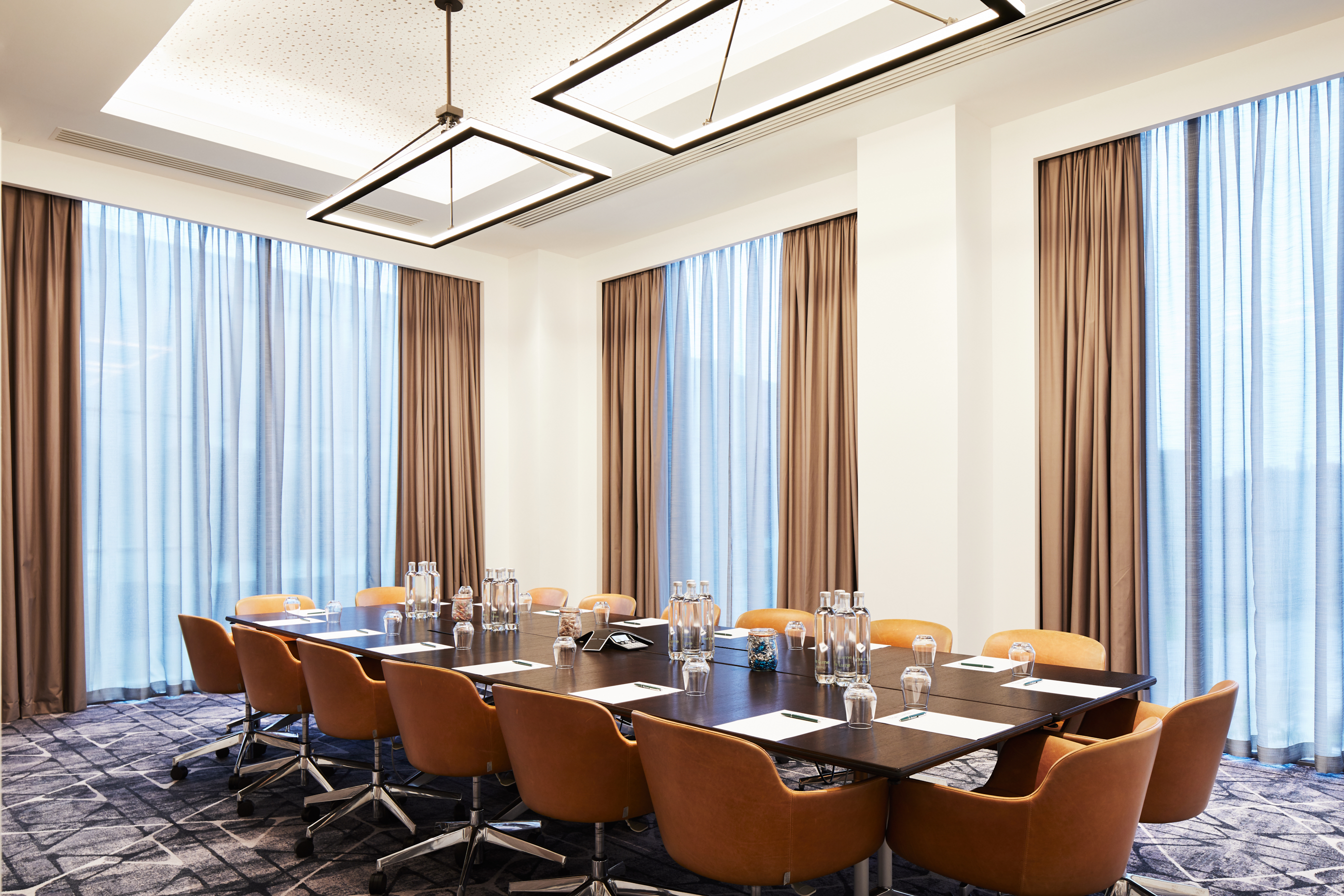 Modern Executive Boardroom at Hyatt Regency Manchester with large table and natural light. - Banner
