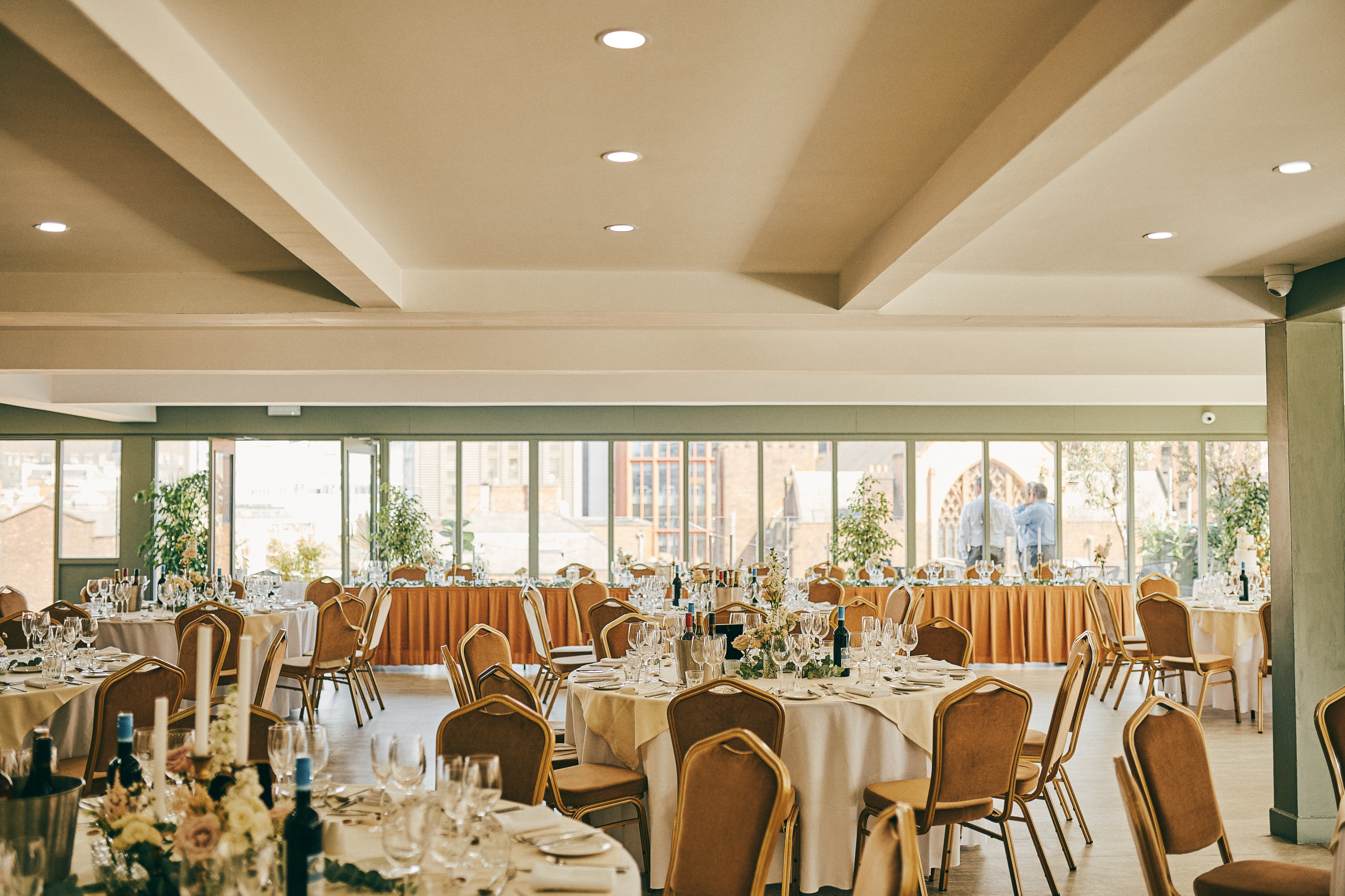 John Rylands Rooftop event space with elegant tables, ideal for gatherings and networking. - Banner