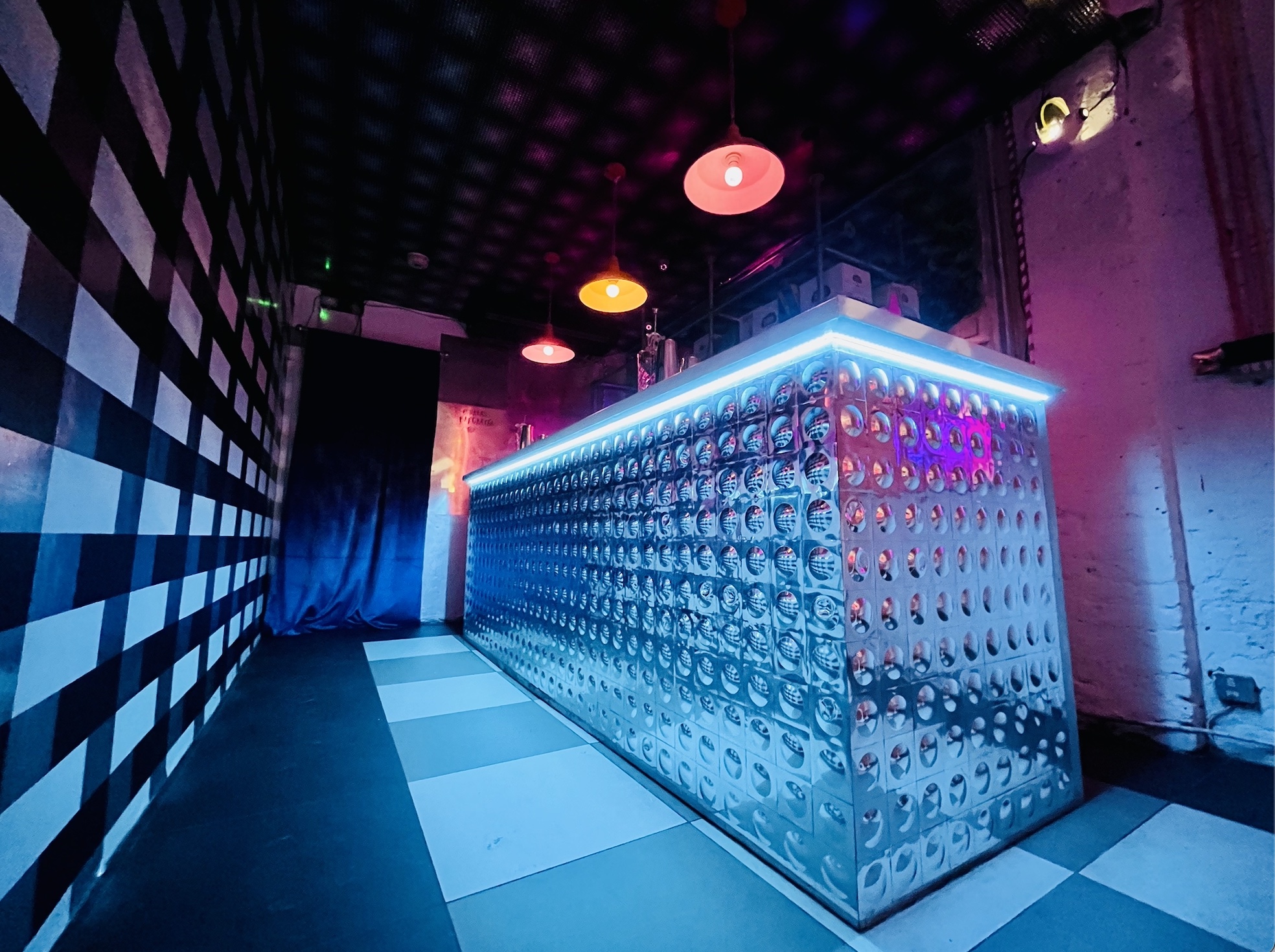 Sleek Bonkers Bar with metallic counter, ideal for cocktail receptions and social gatherings.