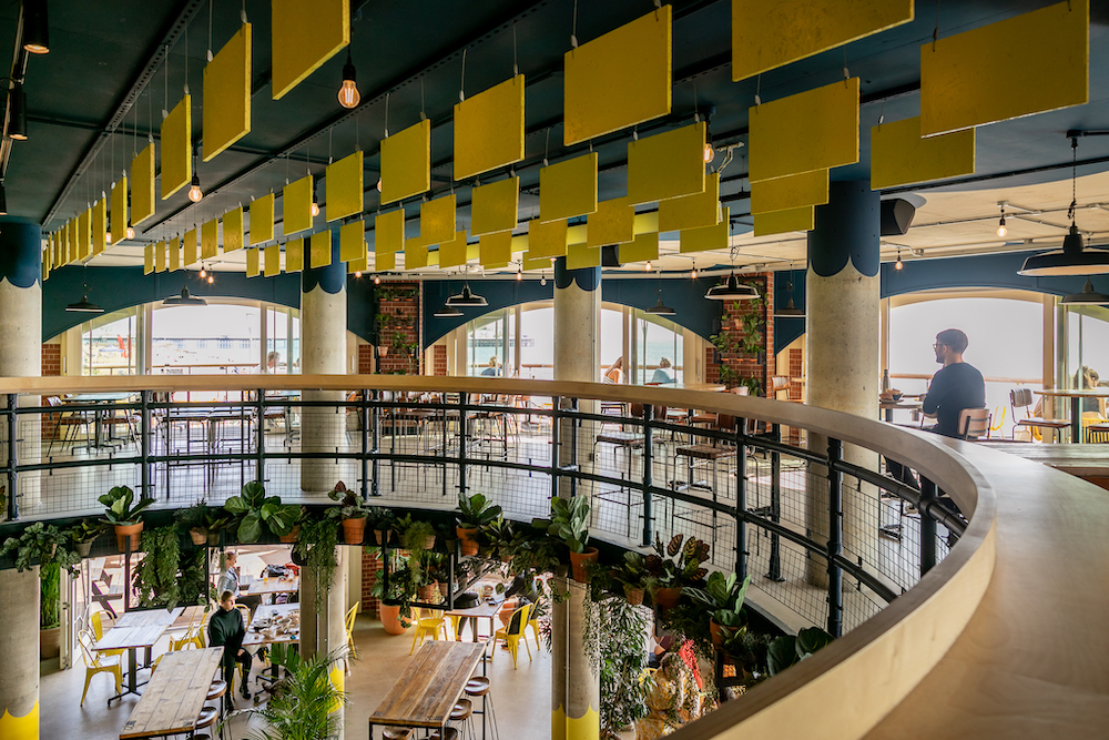 Vibrant modern event space with natural light, ideal for networking and gatherings.