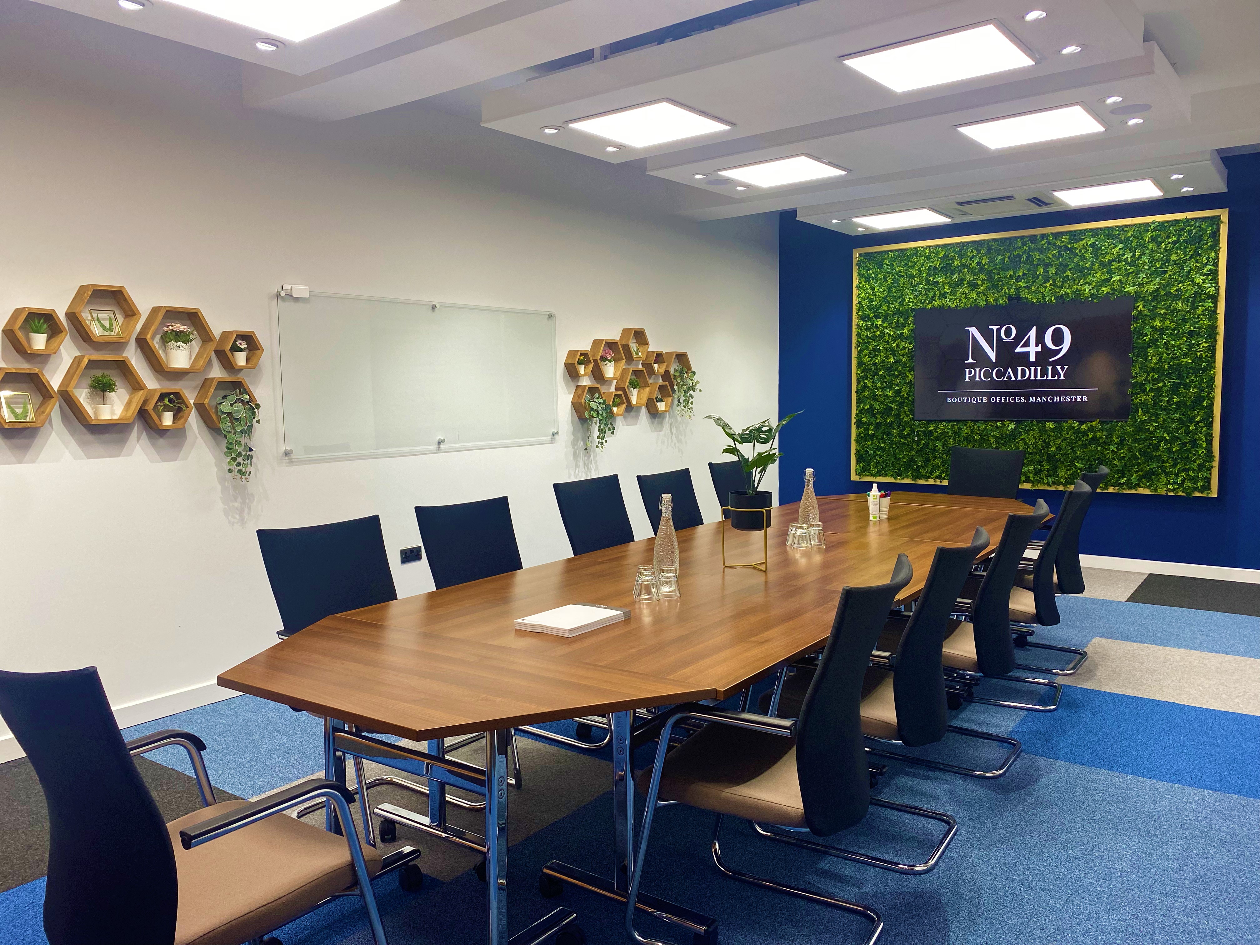 Modern conference room at Crompton, featuring a sleek wooden table for meetings.