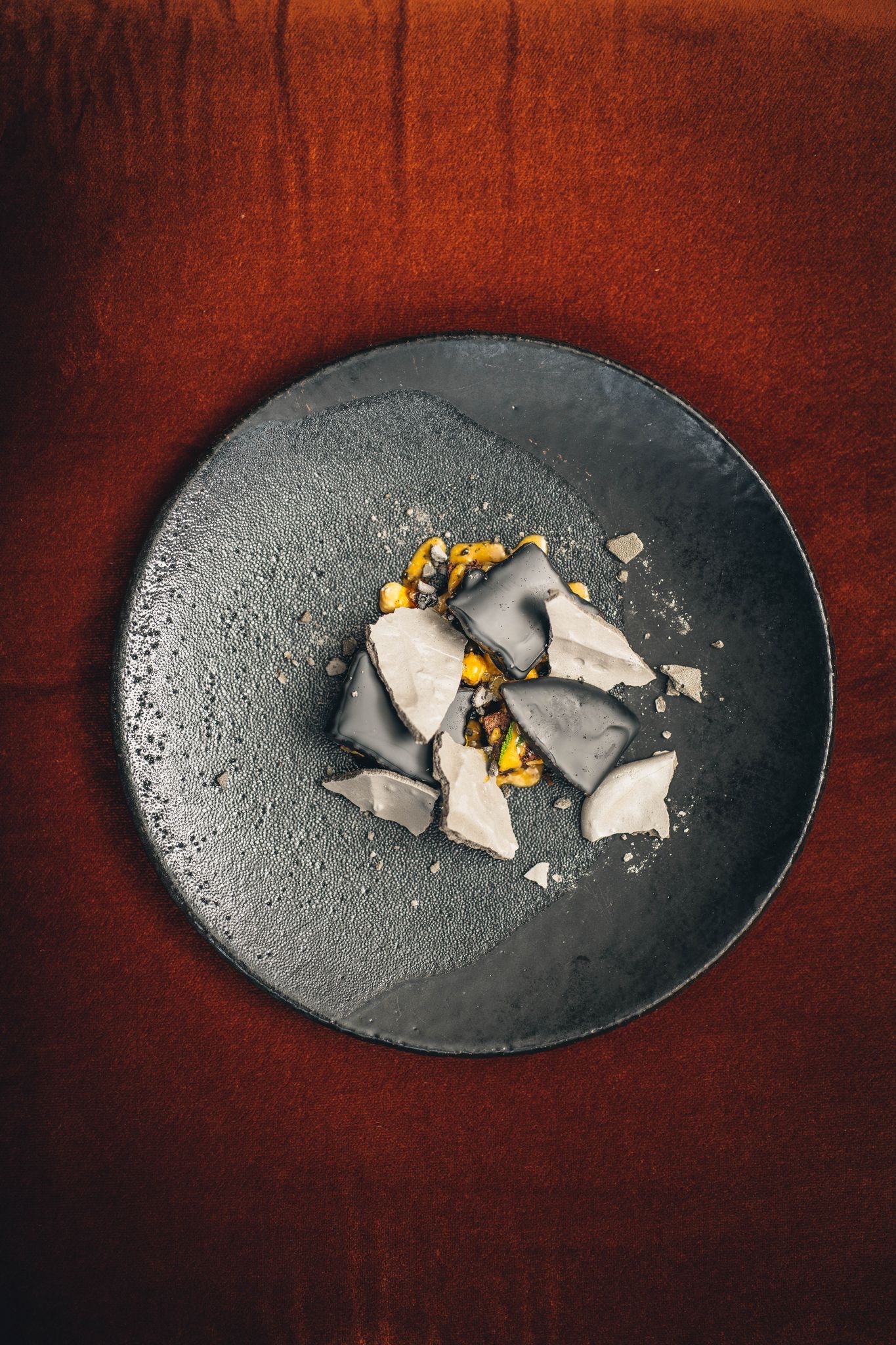 Artistic chocolate and corn dessert plating for high-end corporate catering and event dining.