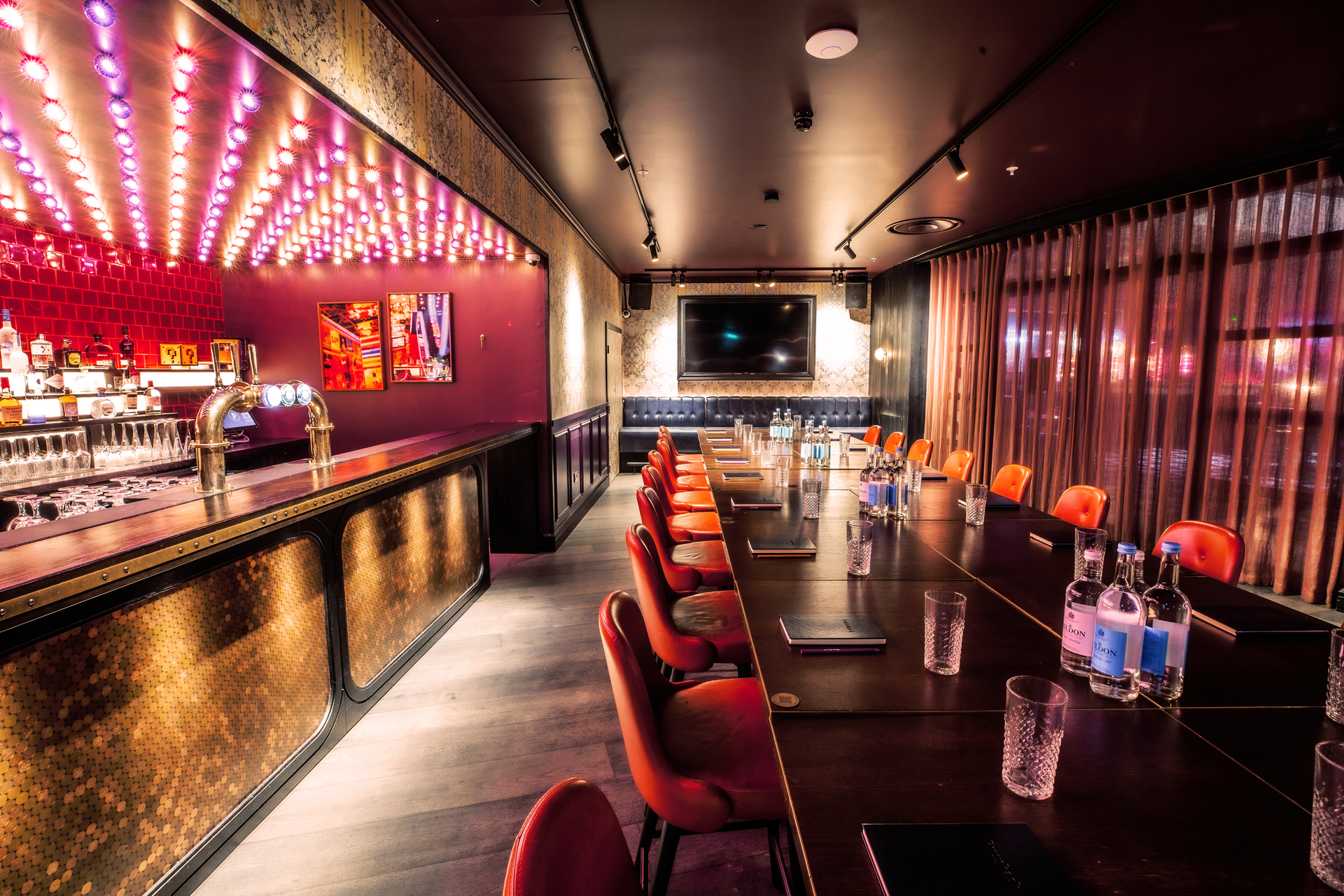 Ruby Rose Private Room at Puttshack Bank, sleek table for corporate meetings and events.