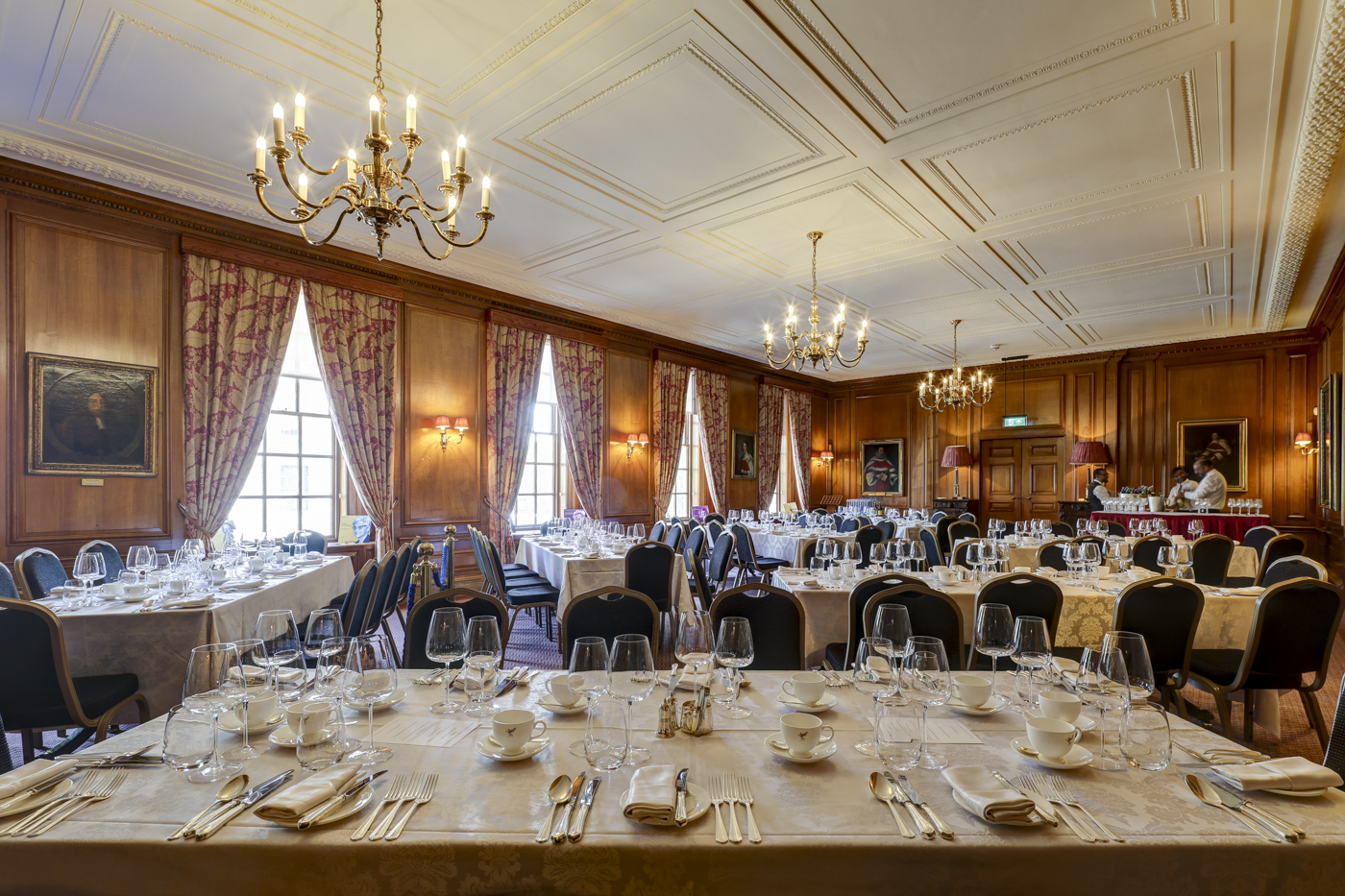 Formal banquet setup in Inner Temple Parliament Chamber with wood paneling for corporate events.