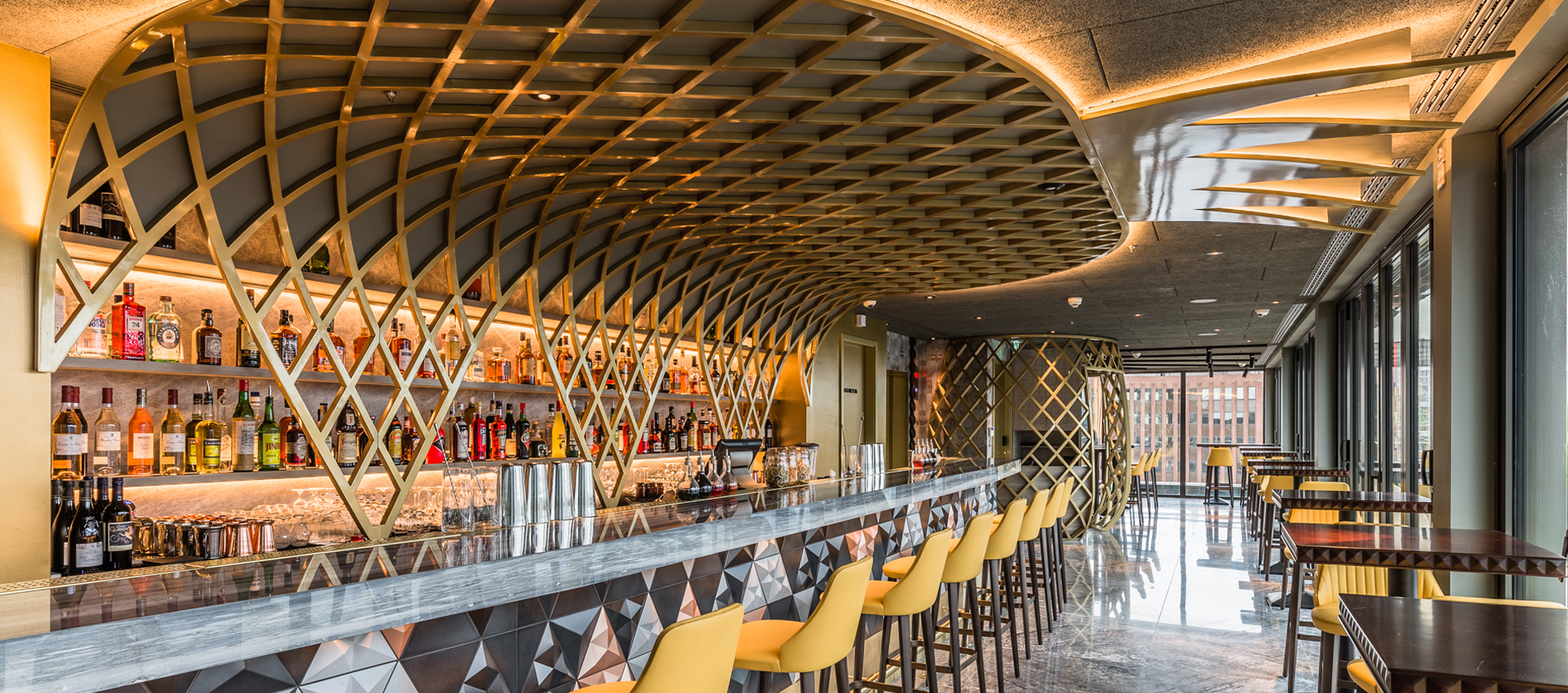 Semi-private hire at Jin Bo Law, featuring a sleek bar and geometric ceiling for cocktail receptions. - Banner