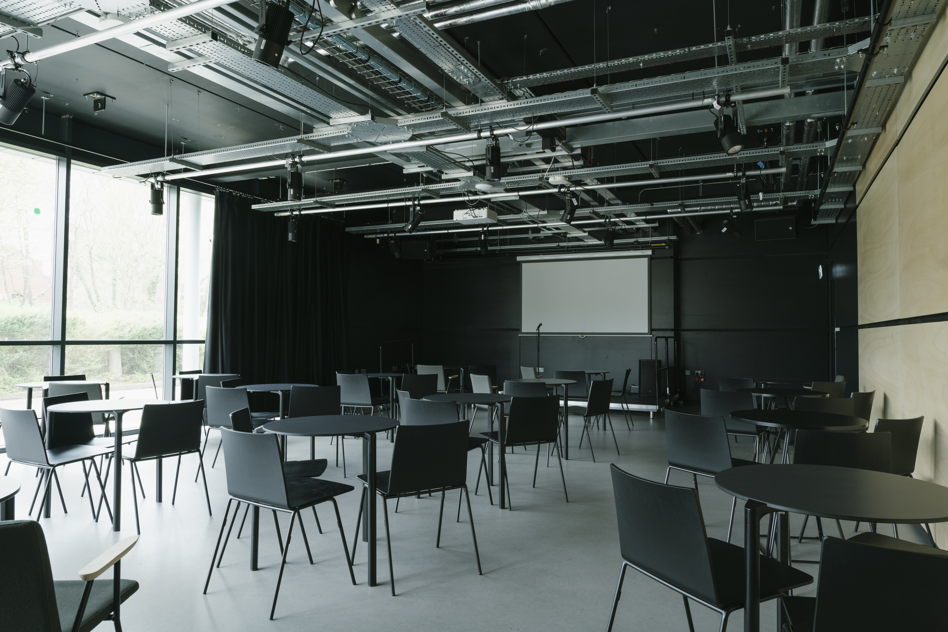 Versatile event space in Contact Theatre with modular seating and natural light for workshops.