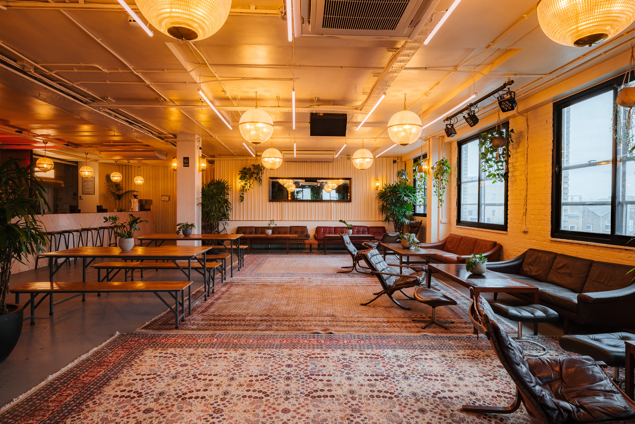 Industrial chic loft venue for networking and social events with flexible lounge seating. - Banner
