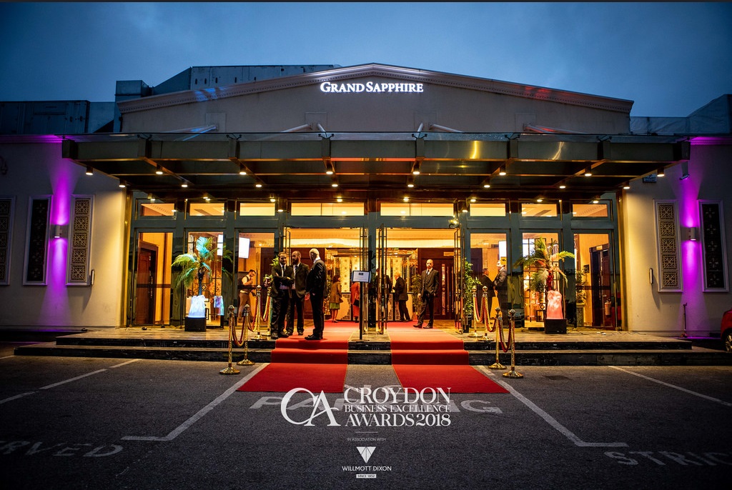 Grand Sapphire Hotel ballroom with red carpet, ideal for award ceremonies and celebrations. - Banner