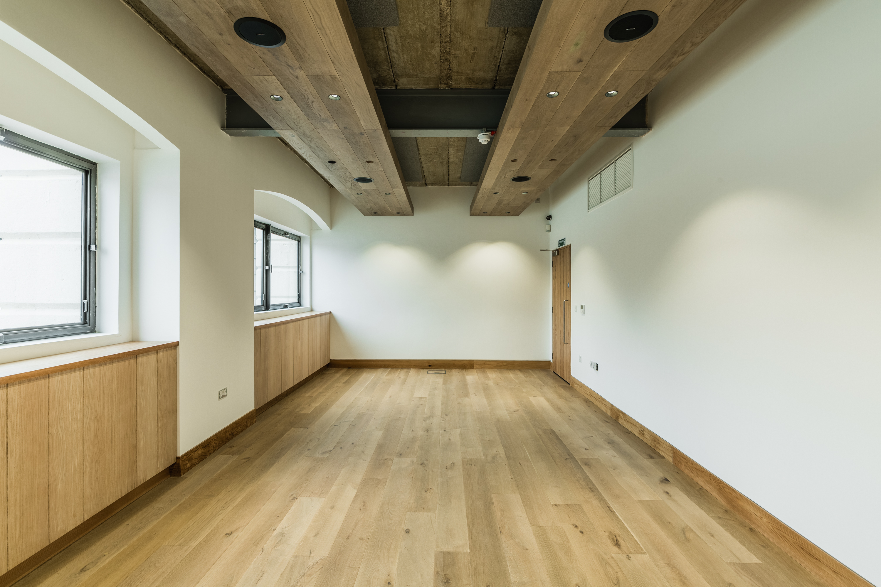 Thames Room at Glaziers Hall: modern event space with warm wood accents for meetings.