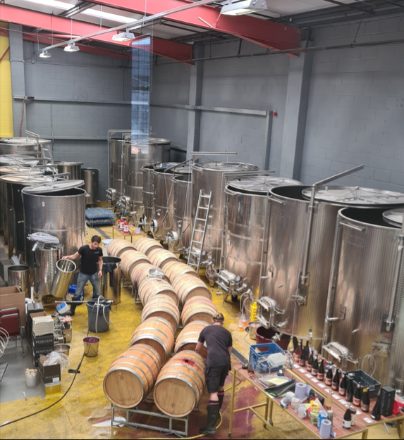 Spacious industrial venue with stainless steel tanks for unique events and tastings. - Banner