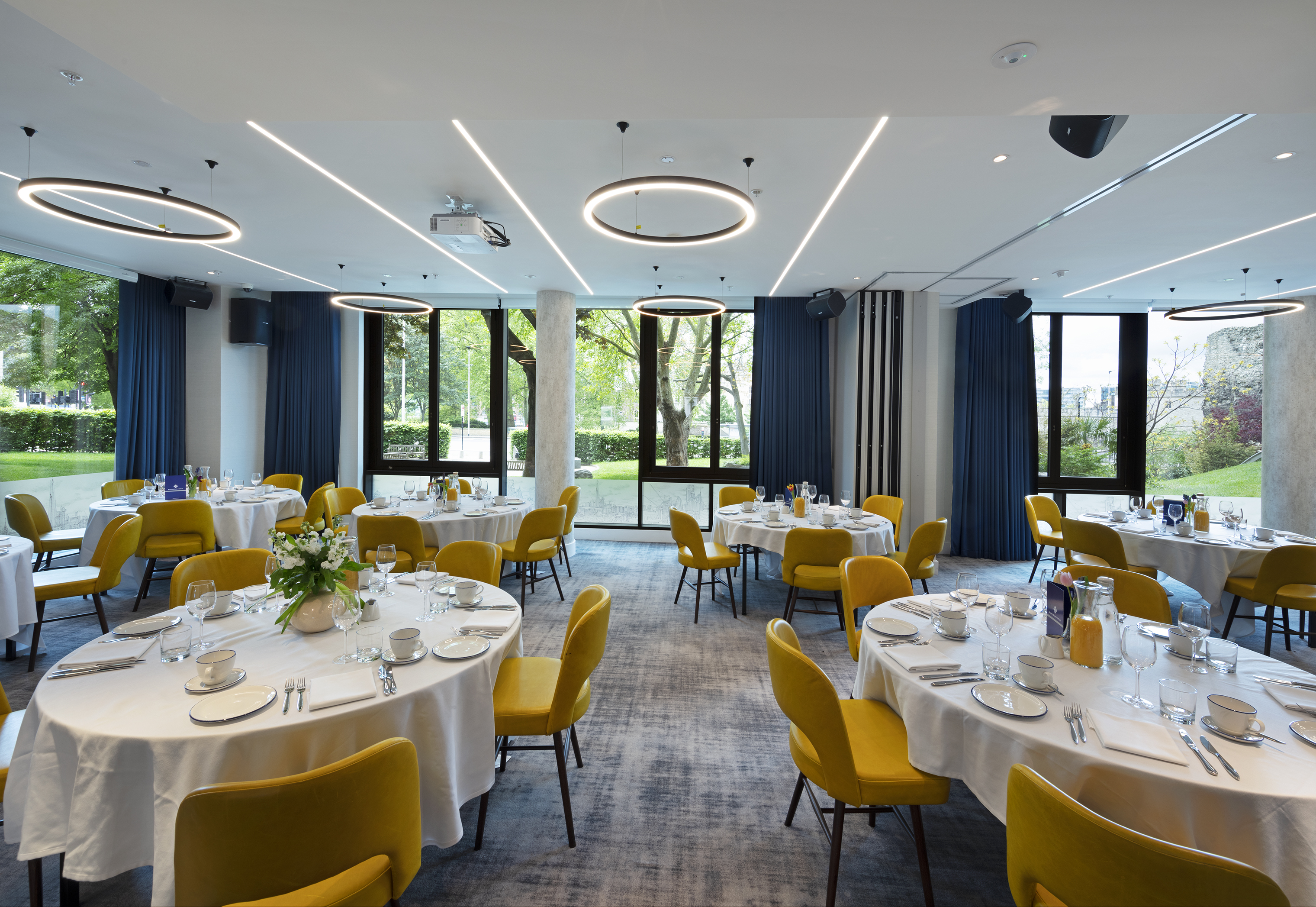 City Suite banquet room at Tower Suites with yellow chairs for corporate events and gala dinners.