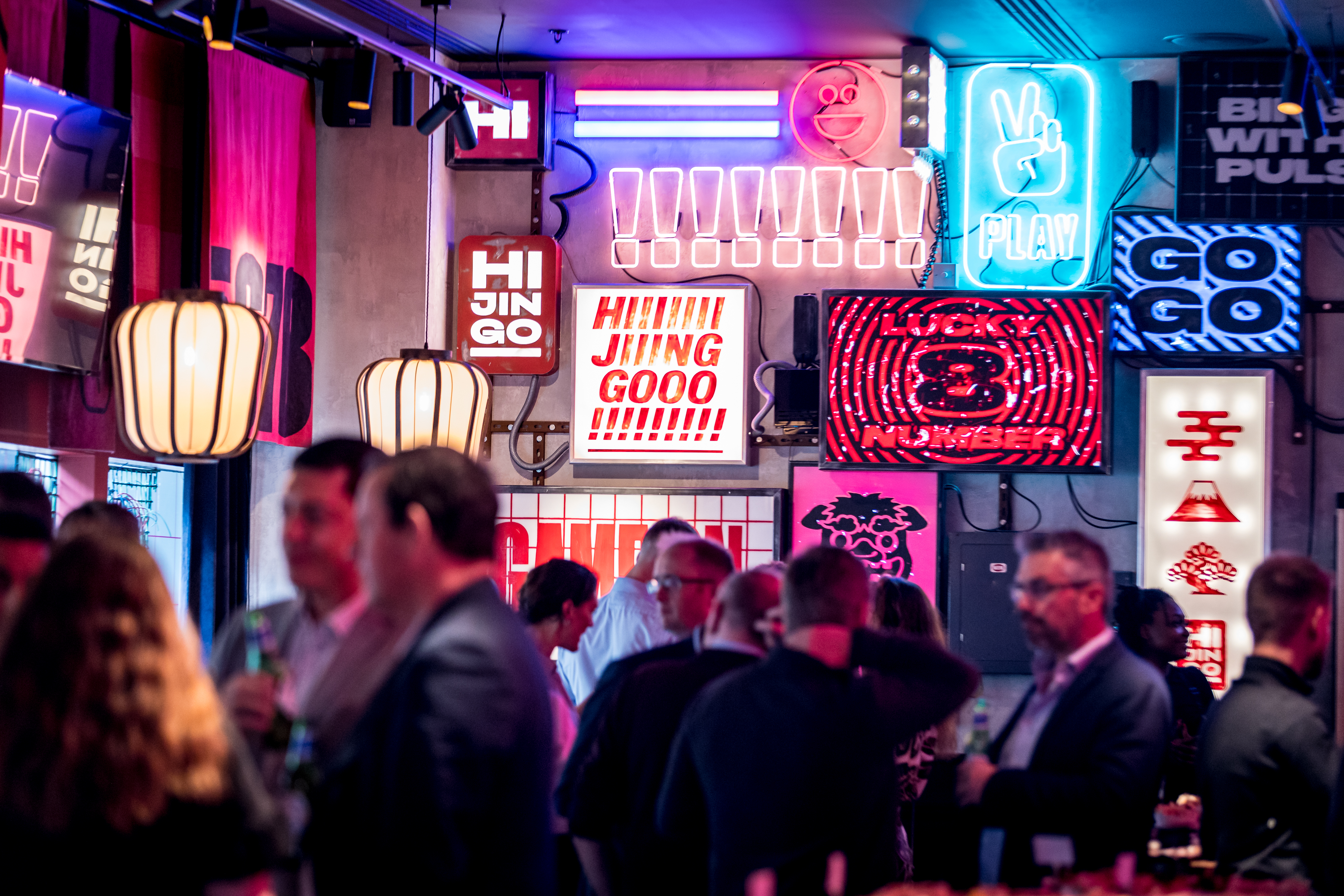 Vibrant Lucky Cat Bar event space with neon lights, ideal for networking and social gatherings.