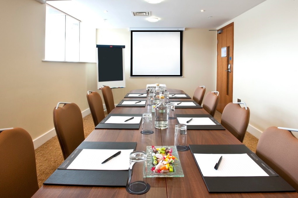 Meeting room setup at Voco St David's Cardiff with natural light for professional events.