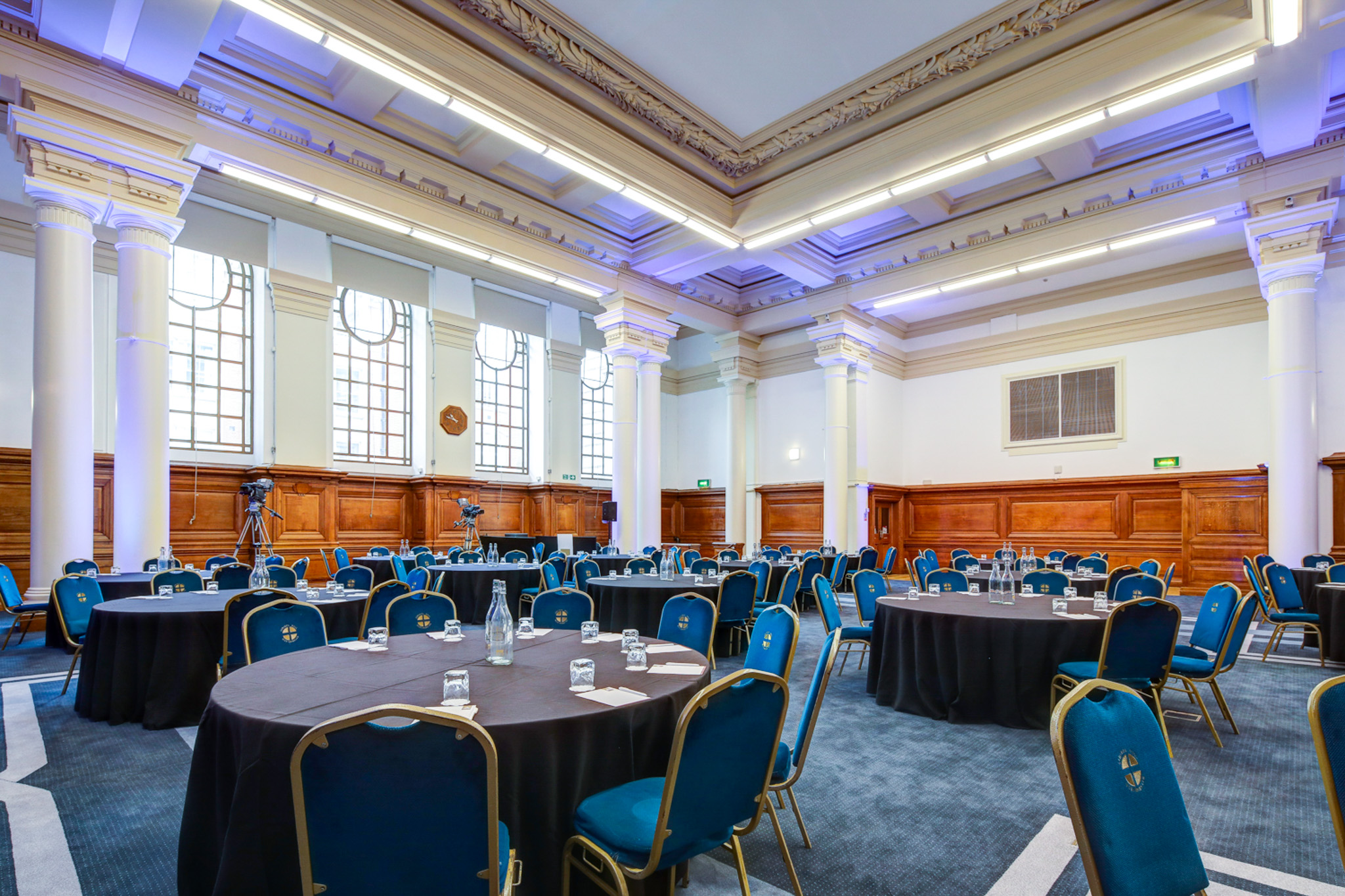 Lecture Hall in Central Hall Westminster with round tables, ideal for conferences and events.