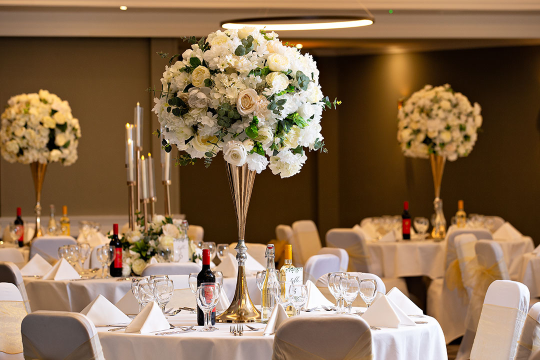 Elegant Ealing Suite with floral centerpieces, ideal for weddings and upscale events. - Banner