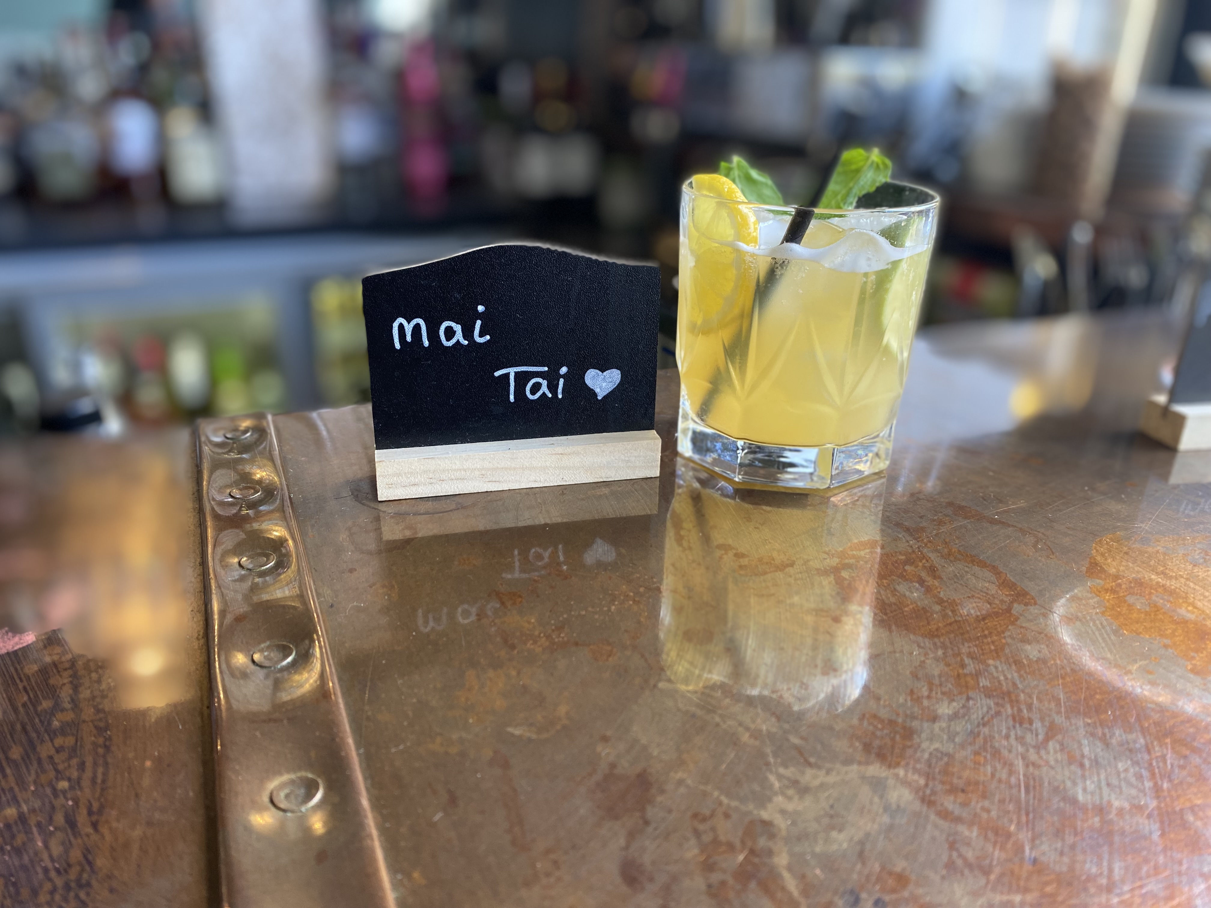 Mai Tai cocktail on polished bar, showcasing upscale event beverage presentation. - Banner