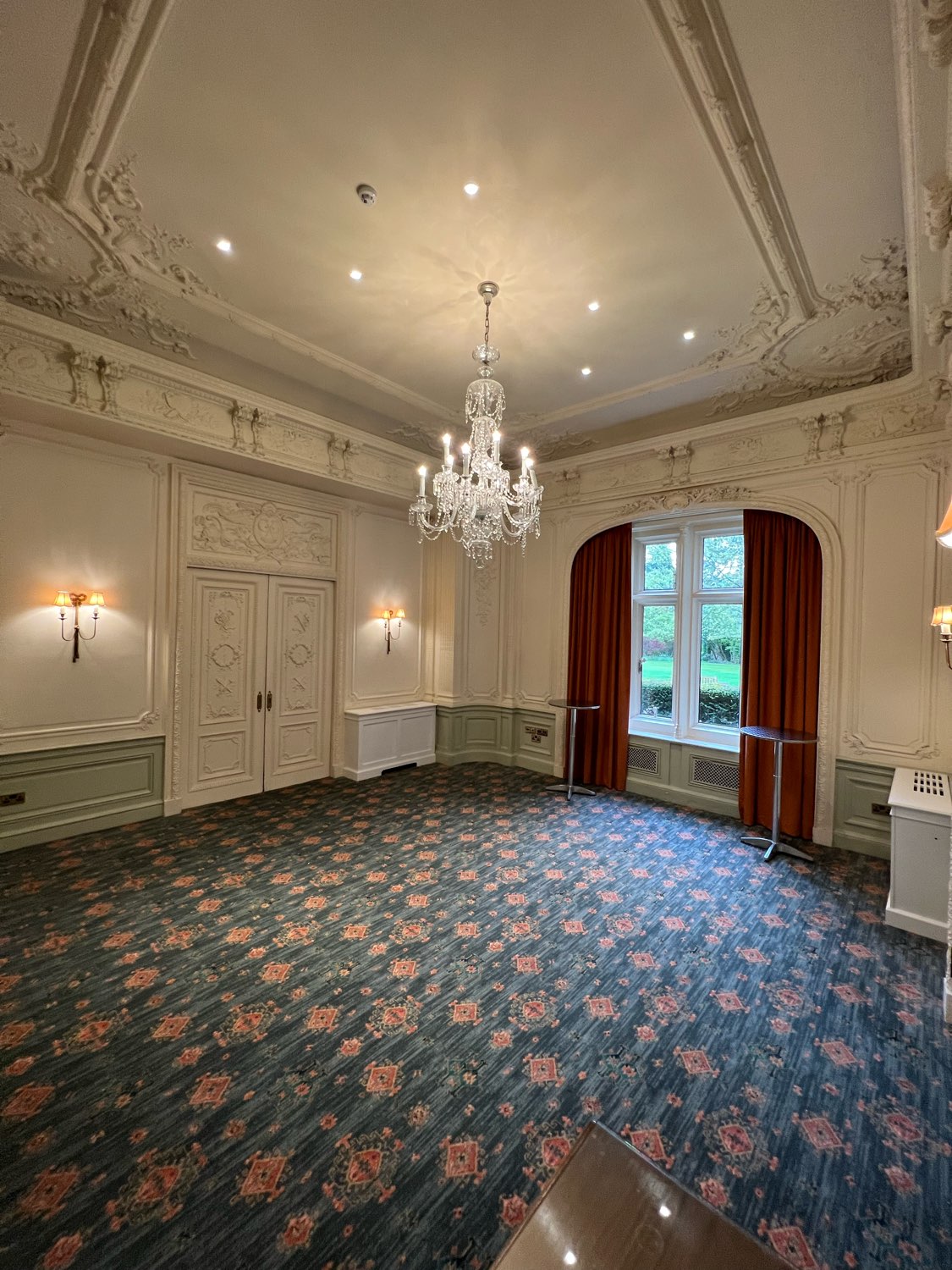 Elegant meeting space with chandelier at Warren House Hotel for corporate events.