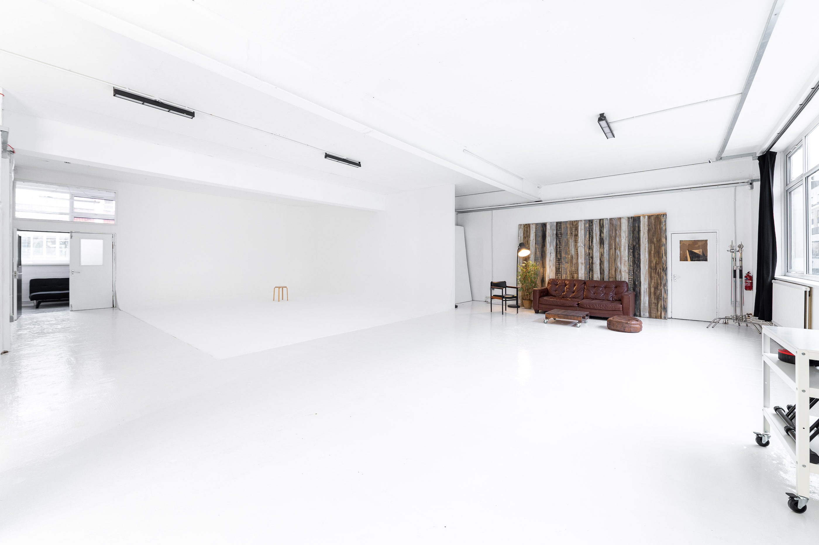 Versatile event space with bright white walls, perfect for workshops and photo shoots. - Banner