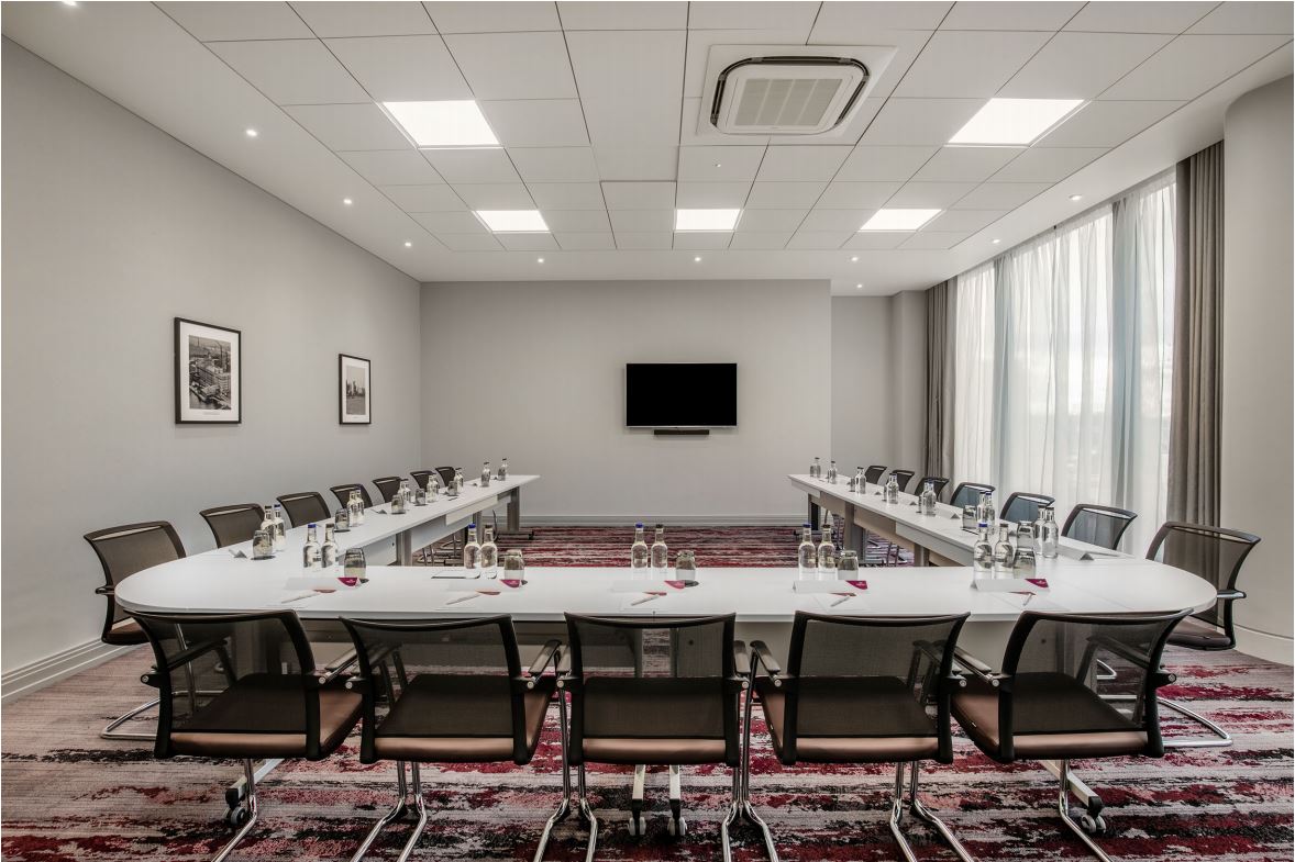 Victoria Suite at Crowne Plaza London Docklands, modern meeting room with U-shaped table setup. - Banner