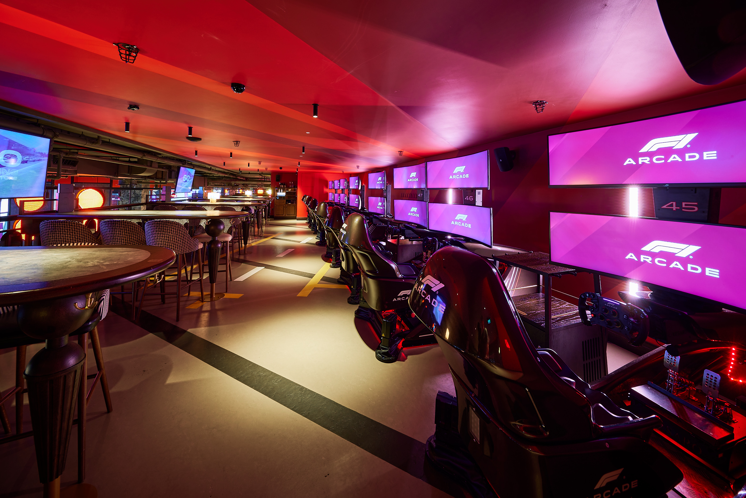 Vibrant F1 Arcade gaming venue with sleek simulators for corporate events and team-building.