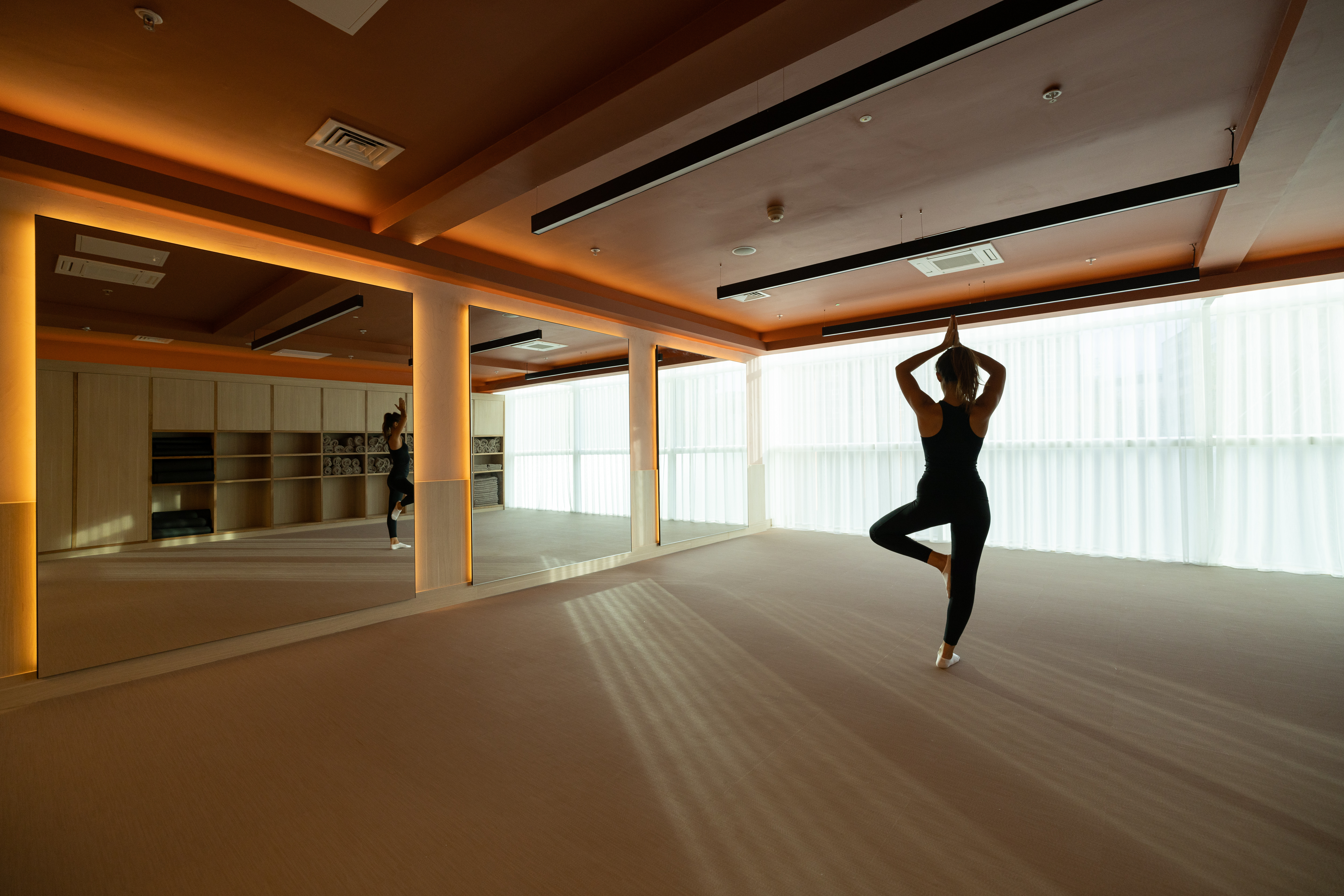 Serene yoga studio with mirrors at RE:TREAT, ideal for wellness retreats and workshops.