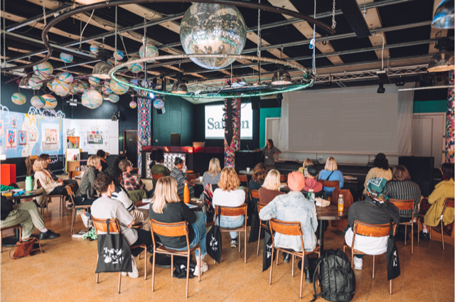 Main room at Strange Brew with hanging globes, ideal for meetings and events. - Banner