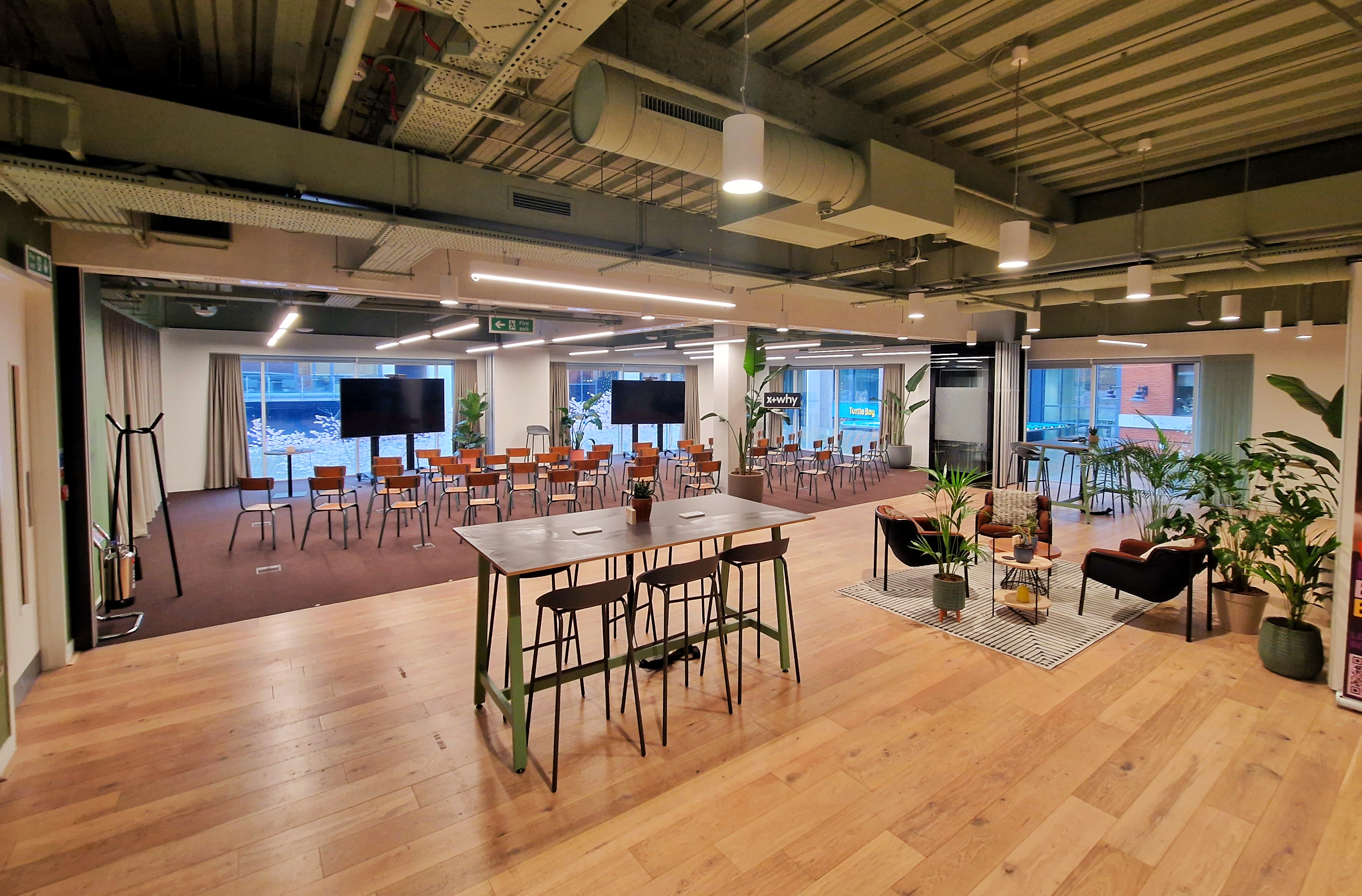 Versatile event space with flexible seating for meetings and social gatherings. - Banner