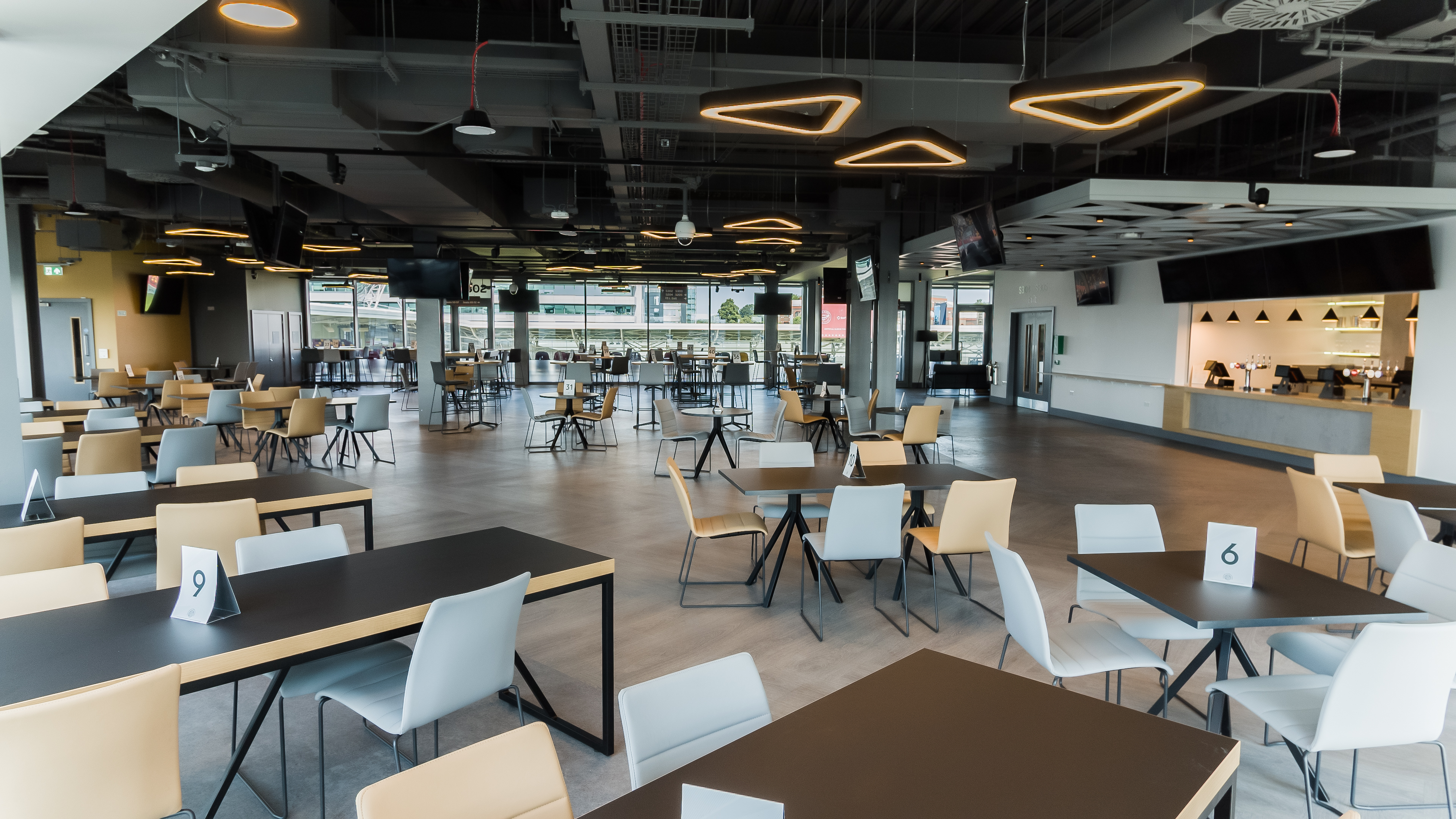 Modern event venue at Brentford FC with flexible seating for corporate events. - Banner