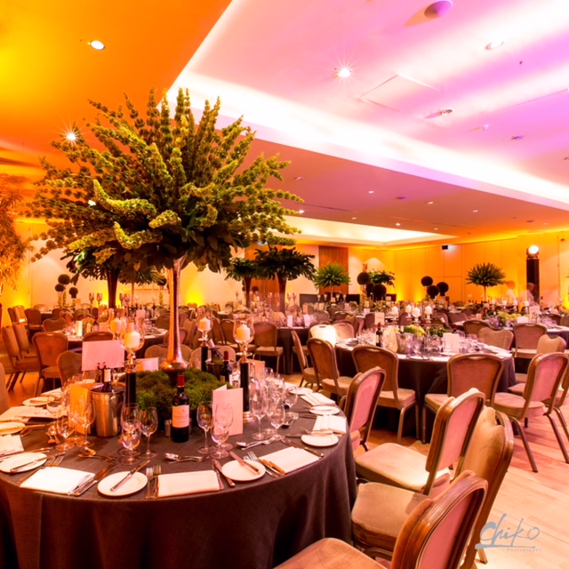 Elegant banquet hall with lush greenery centerpiece for sophisticated events at The Hurlingham Club. - Banner