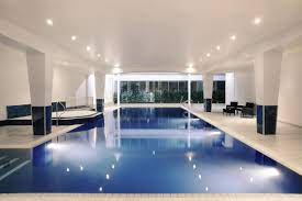 Modern indoor pool at Mercure Cardiff for elegant networking events and retreats. - Banner
