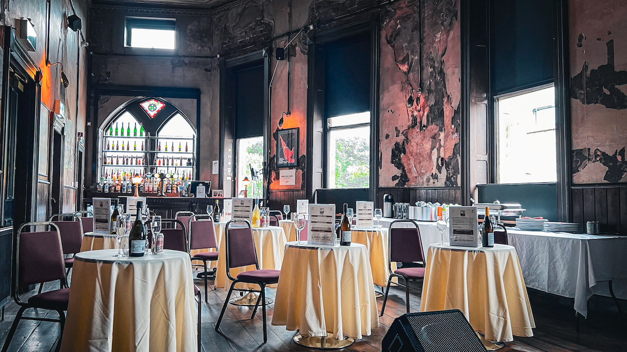 Vintage event space with yellow tables, perfect for networking and dining. - Banner