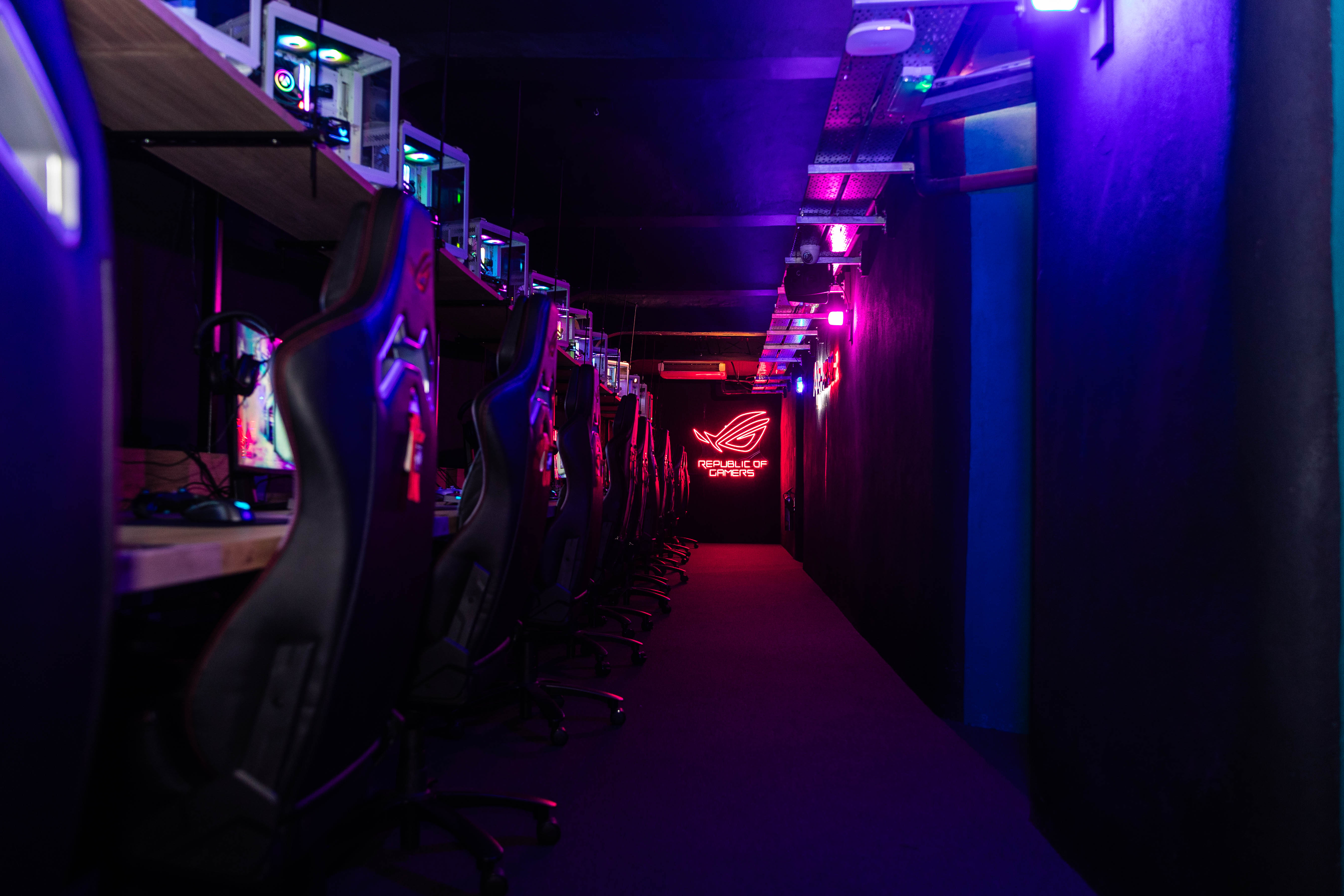 Sleek gaming venue with high-tech stations, ideal for esports tournaments and tech showcases. - Banner