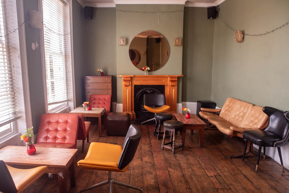 Cozy pub lounge with warm colors, perfect for networking events and meetings.