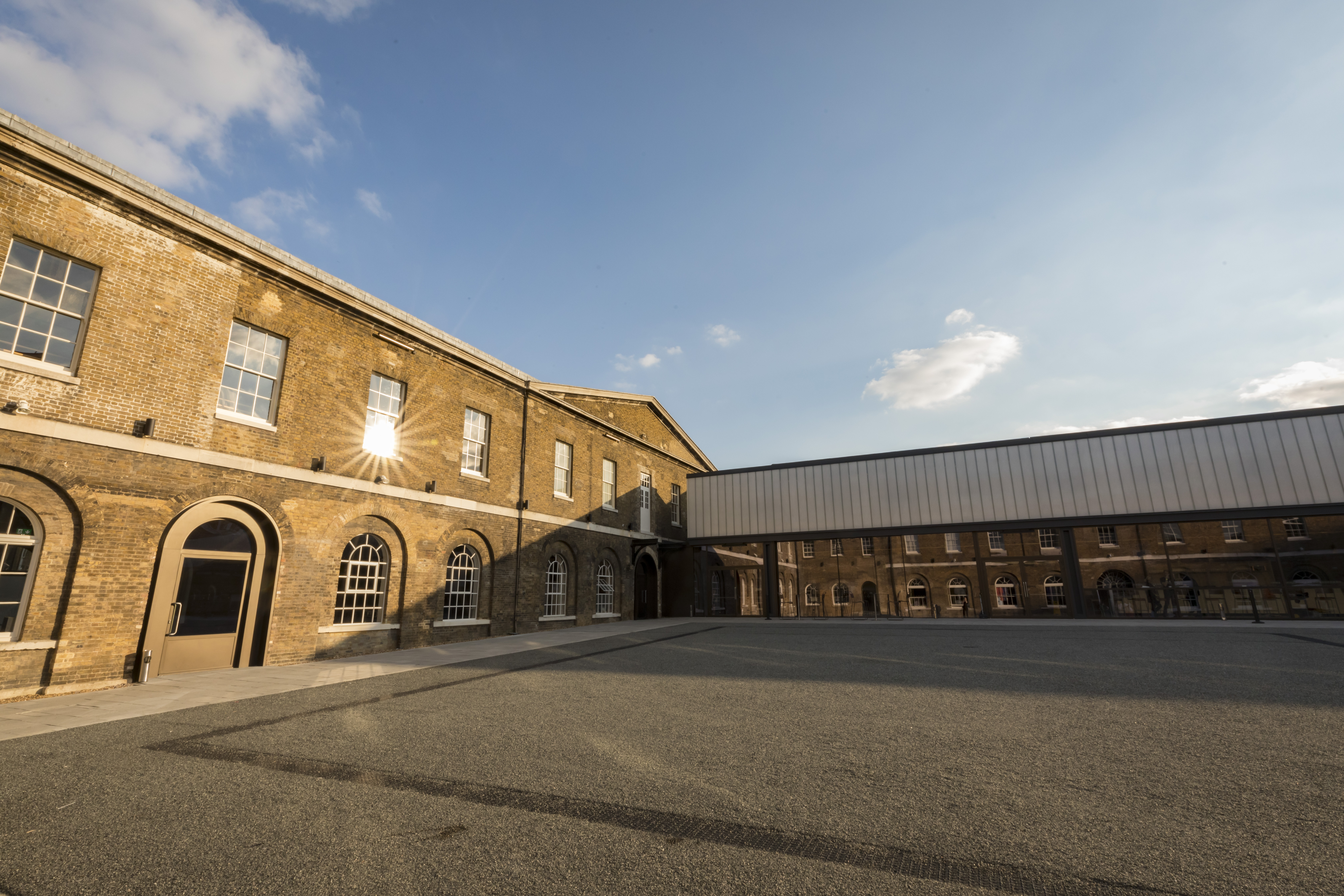 Versatile event space in Woolwich Works with large windows for meetings and gatherings.