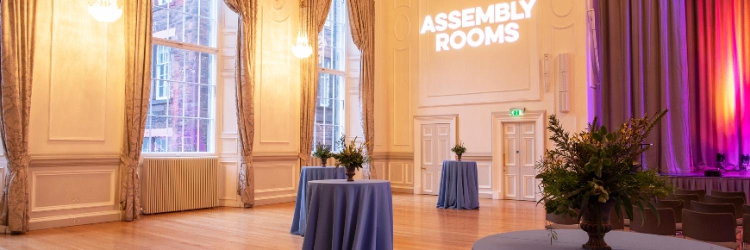 Under-balcony event space with elegant drapery, ideal for corporate events and gatherings. - Banner