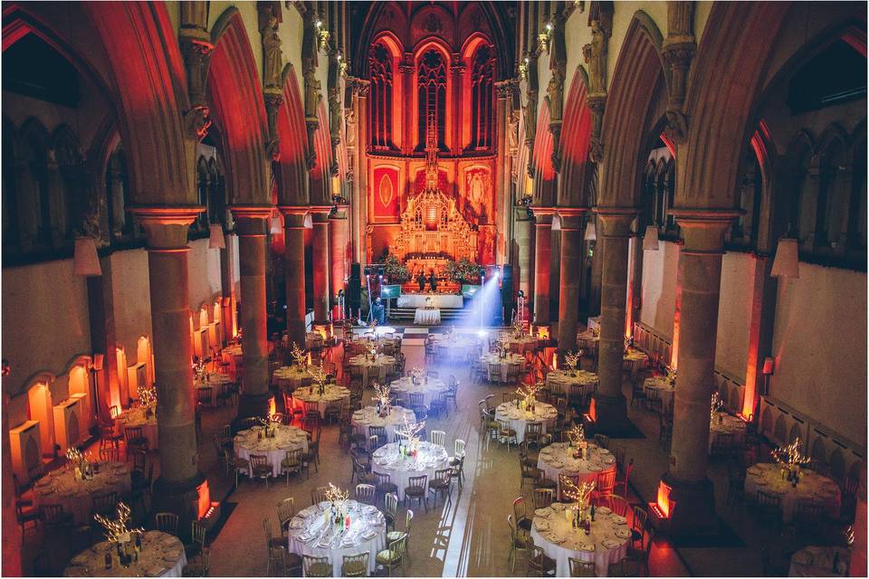 Corporate event space in Manchester Monastery with elegant round tables and soft lighting. - Banner