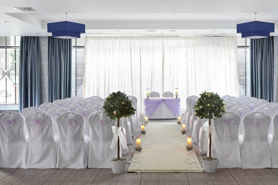 Elegant wedding event space with lavender accents and candlelit aisle at Village Hotel Edinburgh. - Banner