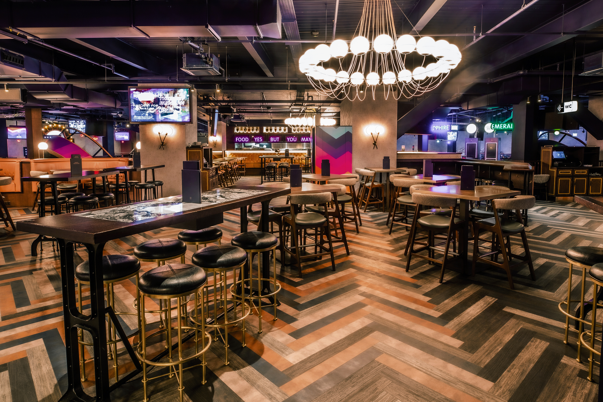 Modern event space at Puttshack Watford with stylish bar, ideal for networking and social events.