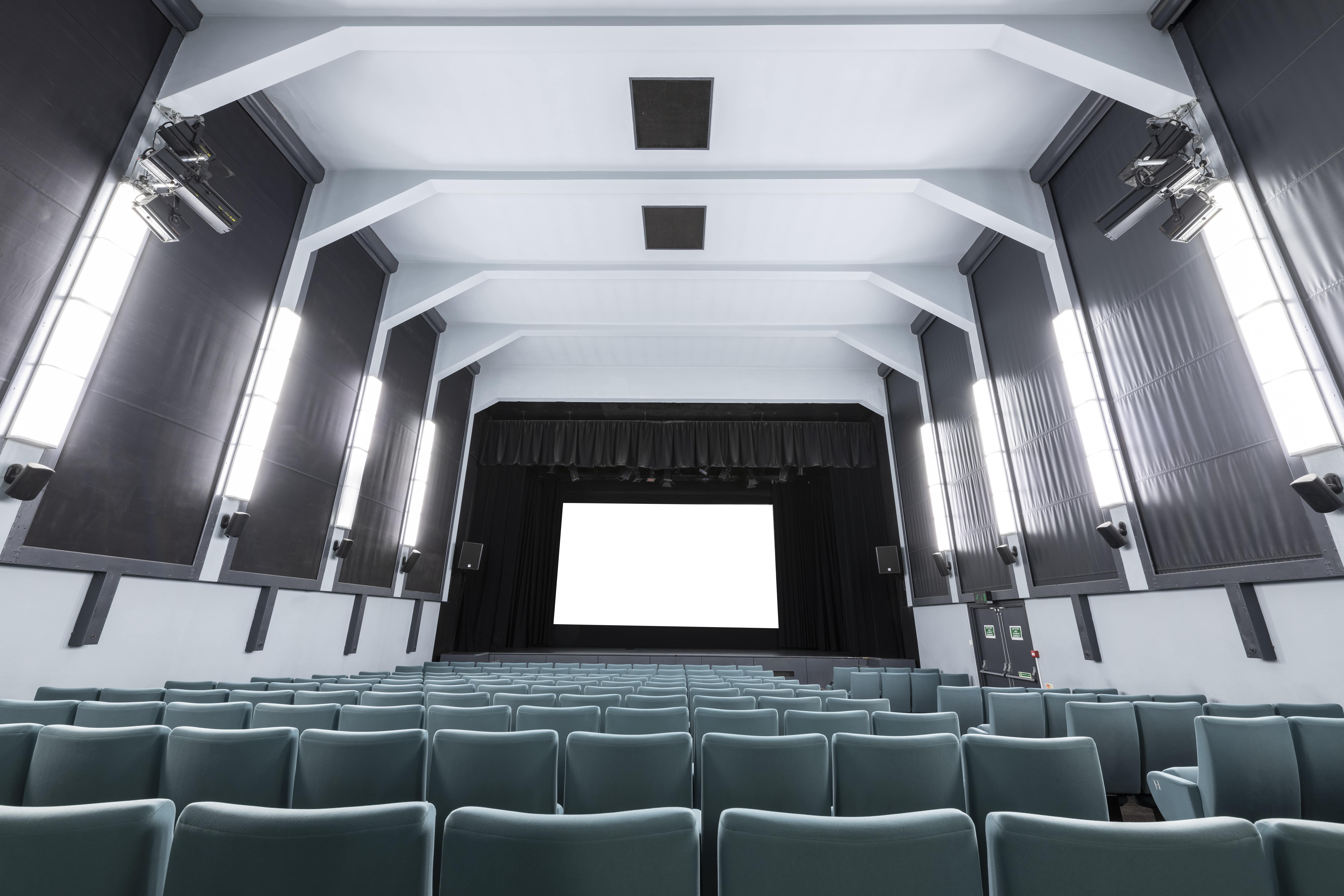 Ciné Lumière auditorium with tiered seating, perfect for events and film screenings.