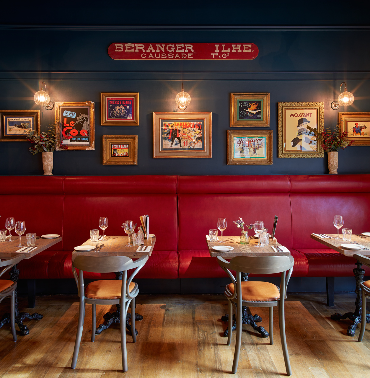 Stylish dining area with red seating at Bistrot Pierre Leicester for corporate events.