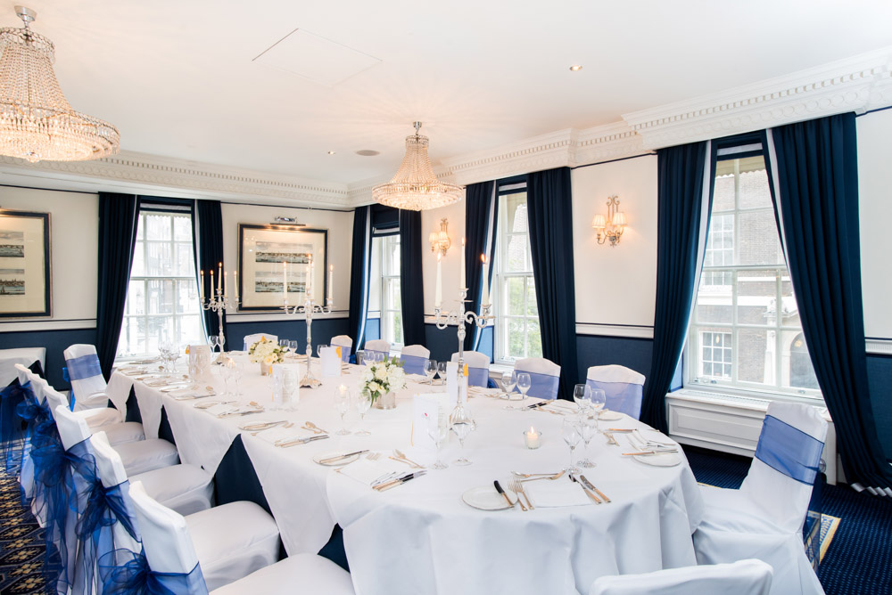 Elegant Queen Suite banquet table with blue accents for corporate events and weddings.
