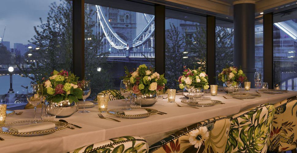 Elegant dining table with floral centerpieces at The View Room, Ivy Tower Bridge, for upscale events. - Banner